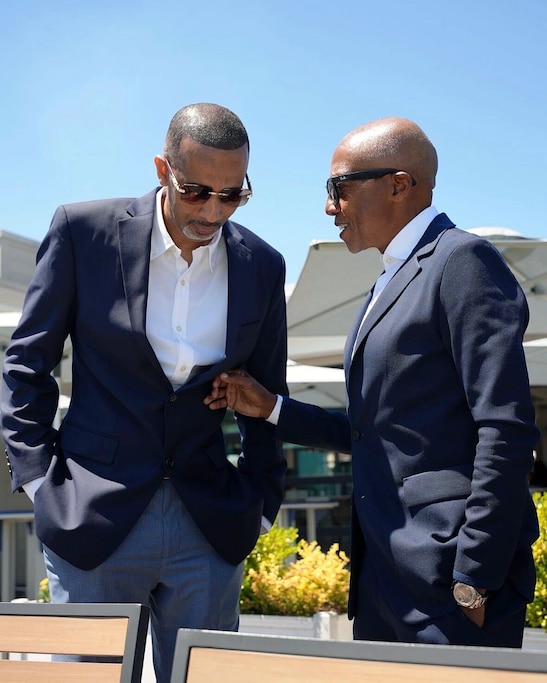 Rapper Mac Phipps, left, speaks with hip-hop executive and Baltimore native Kevin Liles after the signing of Maryland's Protecting Artists’ Creative Expression (PACE) Act on May 12.