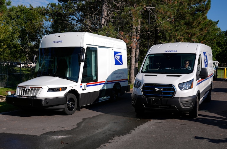 FILE - The U.S. Postal Service's next-generation delivery vehicle, left, is displayed as one new battery electric delivery trucks leaves the Kokomo Sorting and Delivery Center in Kokomo, Ind., Aug. 29, 2024. (AP Photo/Michael Conroy, File)