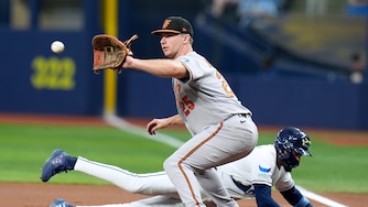 Tampa Bay Rays' Chandler Simpson dives back safely to first ahead of the pickoff throw to Baltimore Orioles' Pete Alonso (25) during the first inning of a baseball game Friday, Aug. 14, 2026, in St. Petersburg, Fla.