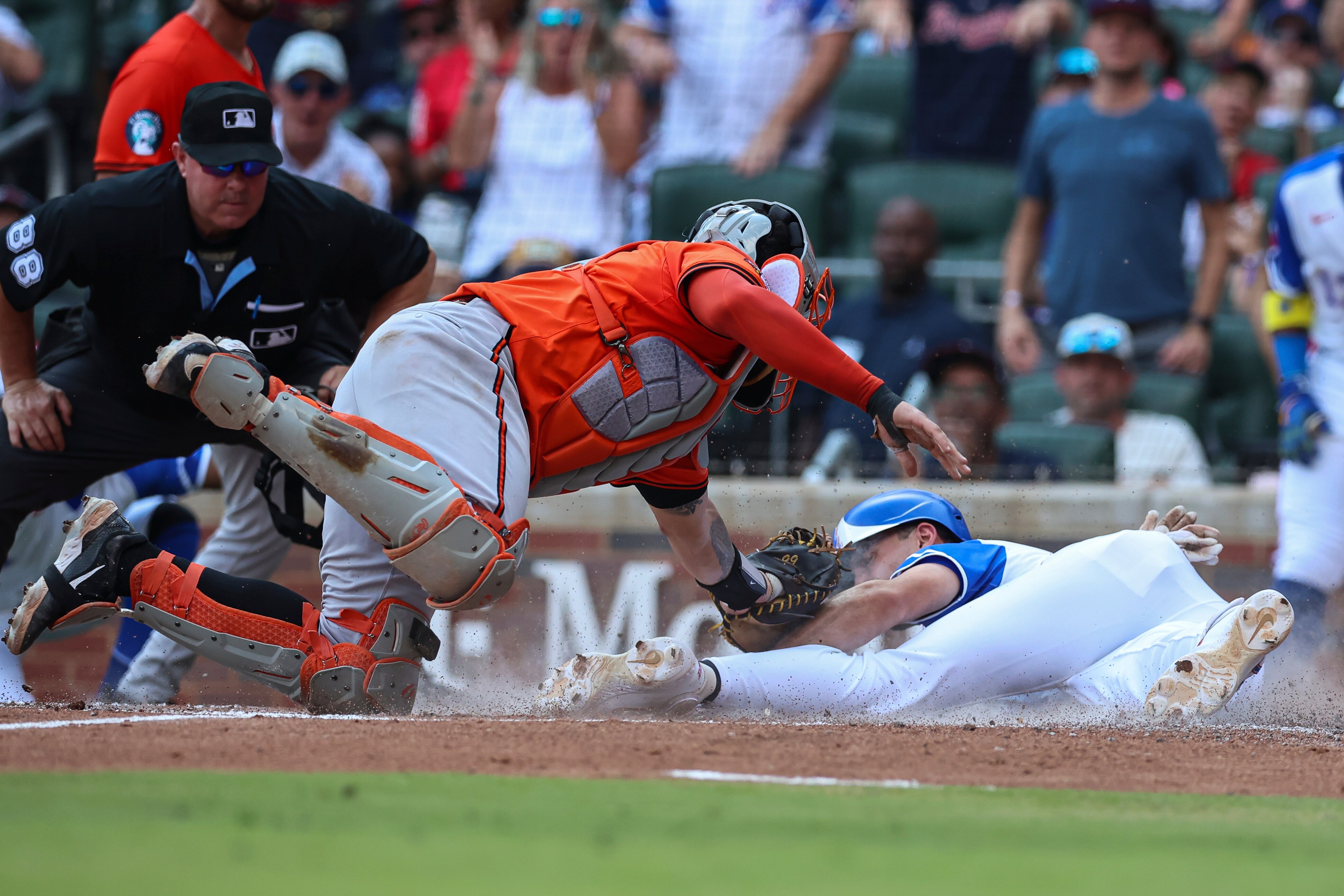 Orioles catcher Gary Sánchez tags out the Braves’ Matt Olson in the fourth inning Saturday before leaving the game because of pain in his right knee.