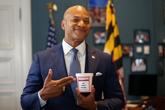 Gov. Wes Moore holds a pint of Taharka Brothers' "We Want Moore" limited edition ice cream.