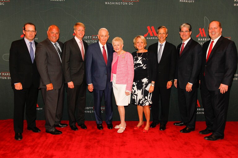 WASHINGTON, DC - JUNE 10: (L-R) Matthew Carroll, Sami Abuzeid, David Marriott, J.W. Marriott. Jr, Mrs. Donna Marriott, Debbie Marriott Harrison, Ron Harrison, Paul Cahill, and Dan Nadeau of Marriott International pose on the red carpet during the grand opening of the The Marriott Marquis Washington D.C., its' 4000th hotel opening on June 10, 2014 in Washington, DC.
