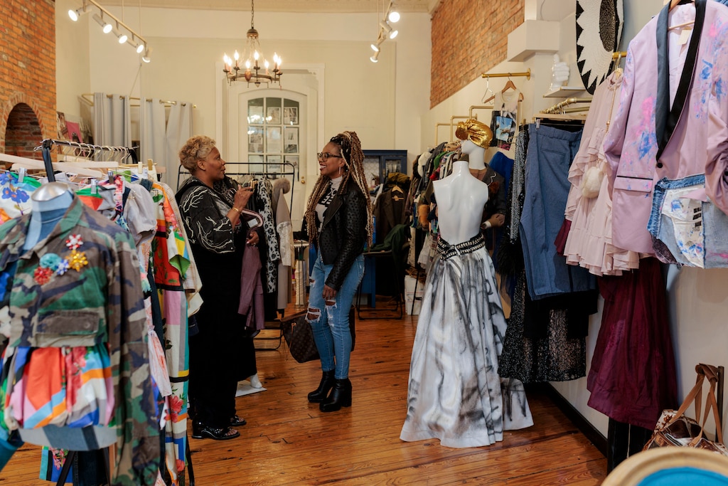 Saturday, April 11, 2026, in Baltimore — Shelonda Stokes, President of the Downtown Partnership of Baltimore and Executive Director of the Downtown Management Authority, chats with designer Natalie Karyl ahead of a suit fitting.