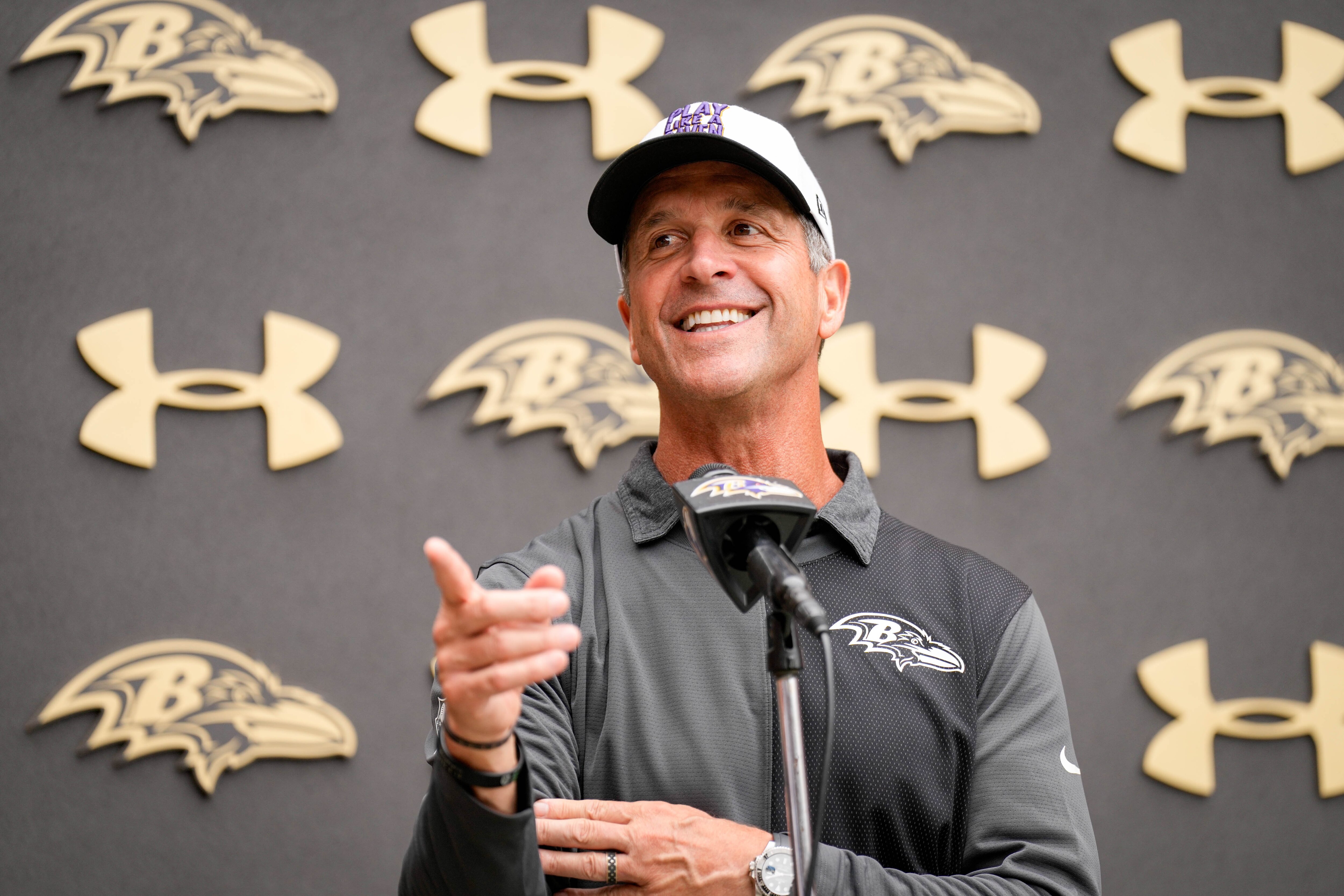 Ravens coach John Harbaugh takes questions from reporters following the team’s practice on Aug. 19.