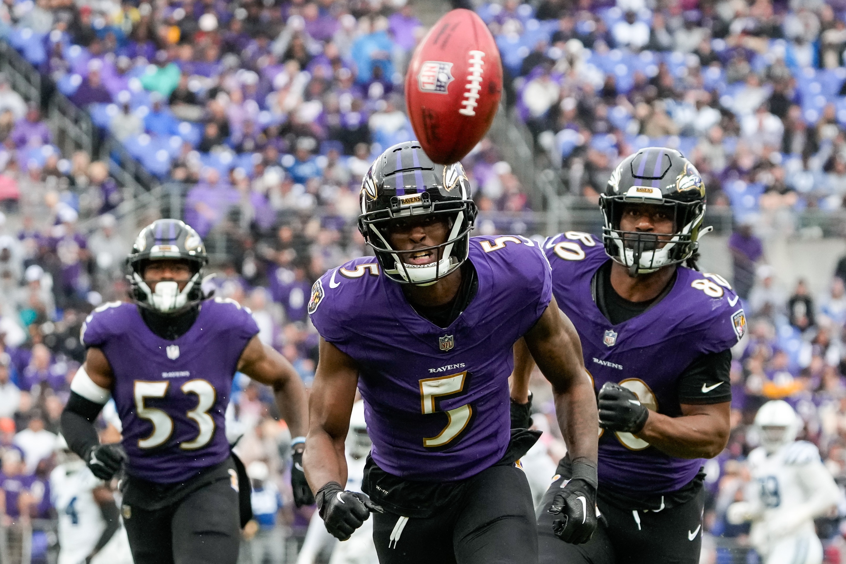 The Ravens' Jalyn Armour-Davis (5), Del'shawn Phillips (53) and Isaiah Likely chase a punt Sunday during a 22-19 overtime loss to Indianapolis.