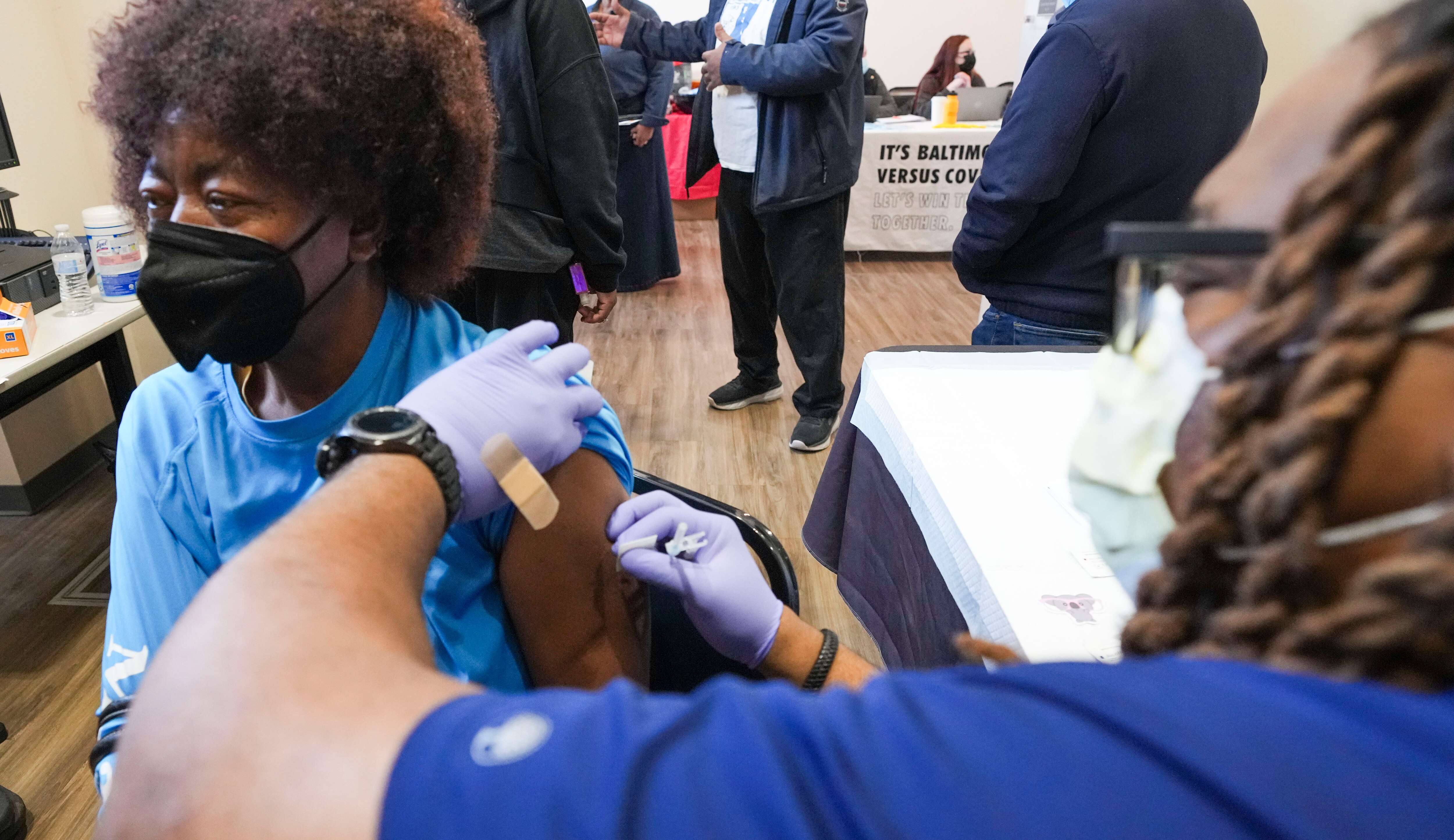 Geraldine Long, a neighborhood resident, comes in to get her COVID booster. Baltimore City's continued effort towards combating COVID-19 includes a stationary mobile clinic that gives vaccine recievers incentives to keep up to date on their vaccines.  A mobile setup is shown here on February 10, 2023.