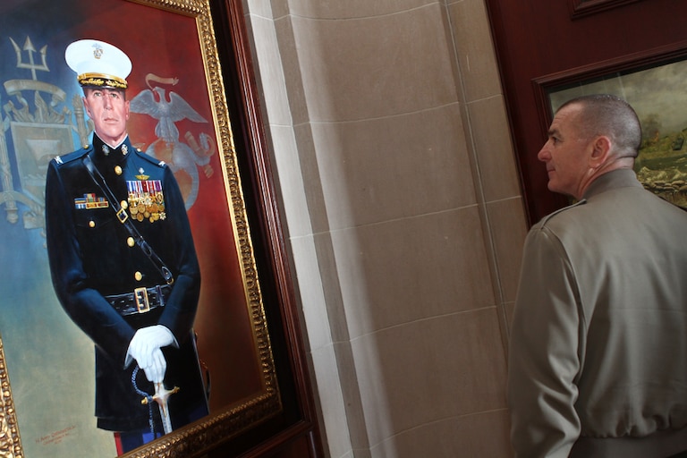 Marine Corps Sgt. Maj. Bryan Battaglia, the senior enlisted adviser to the Chairman of the Joint Chiefs of Staff, stops to look at a painting and diorama placed in Memorial Hall at the U.S. Naval Academy in honor of Marine Corps Col. John Ripley.
