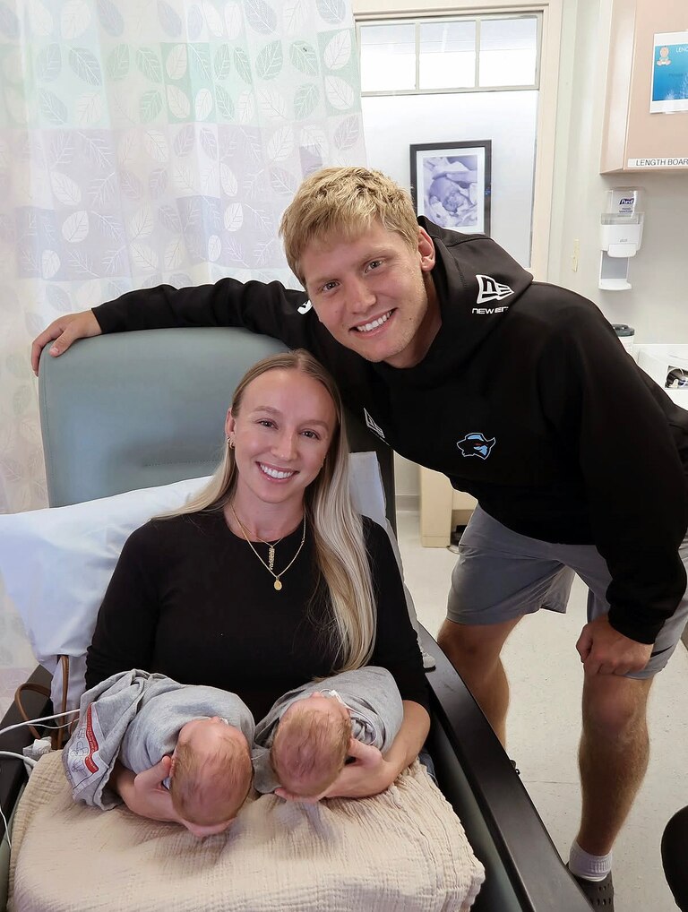Austin Reed with his wife Peyton and their newborn twin daughters earlier this year.