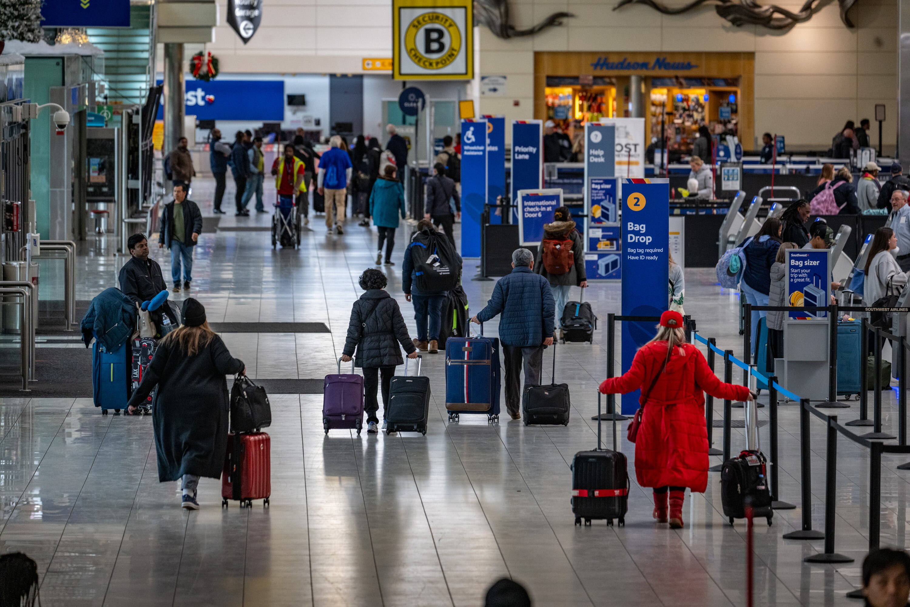 The security pause at the Baltimore-Washington International Thurgood Marshall Airport comes amid the busy holiday travel season. 