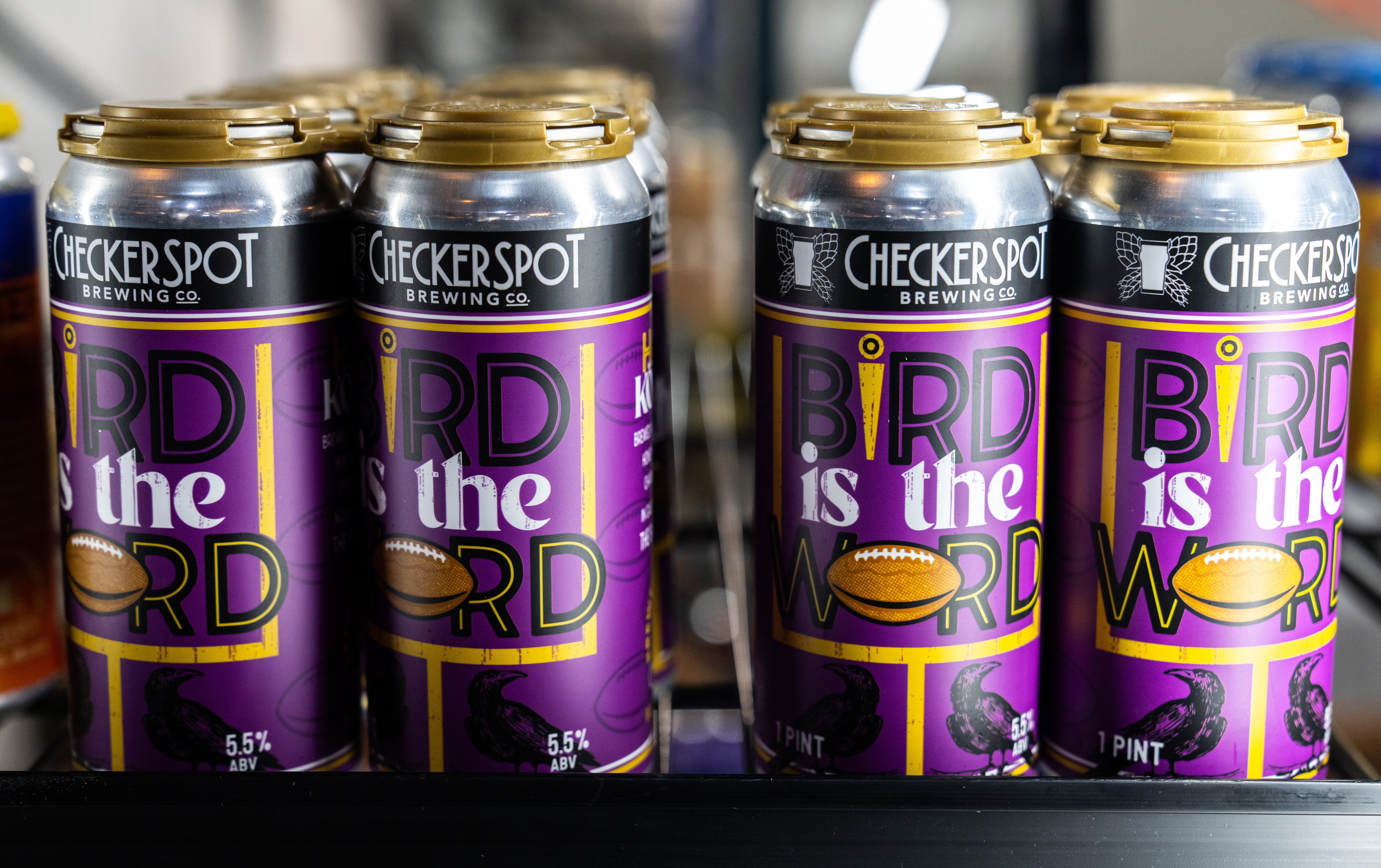 Cans of Checkerspot Brewery’s “Bird is the Word” Kölsch-style beer with a Ravens-themed label. The brewery is a stone’s throw from M&T Bank Stadium.
