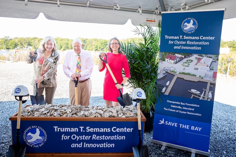 Truman T. Semans, a longtime supporter of the Chesapeake Bay Foundation, helped break ground on a new oyster hatchery and innovation center. He was joined by foundation Vice Chair-elect Ann Pelham, right, and CBF President Hilary Harp.