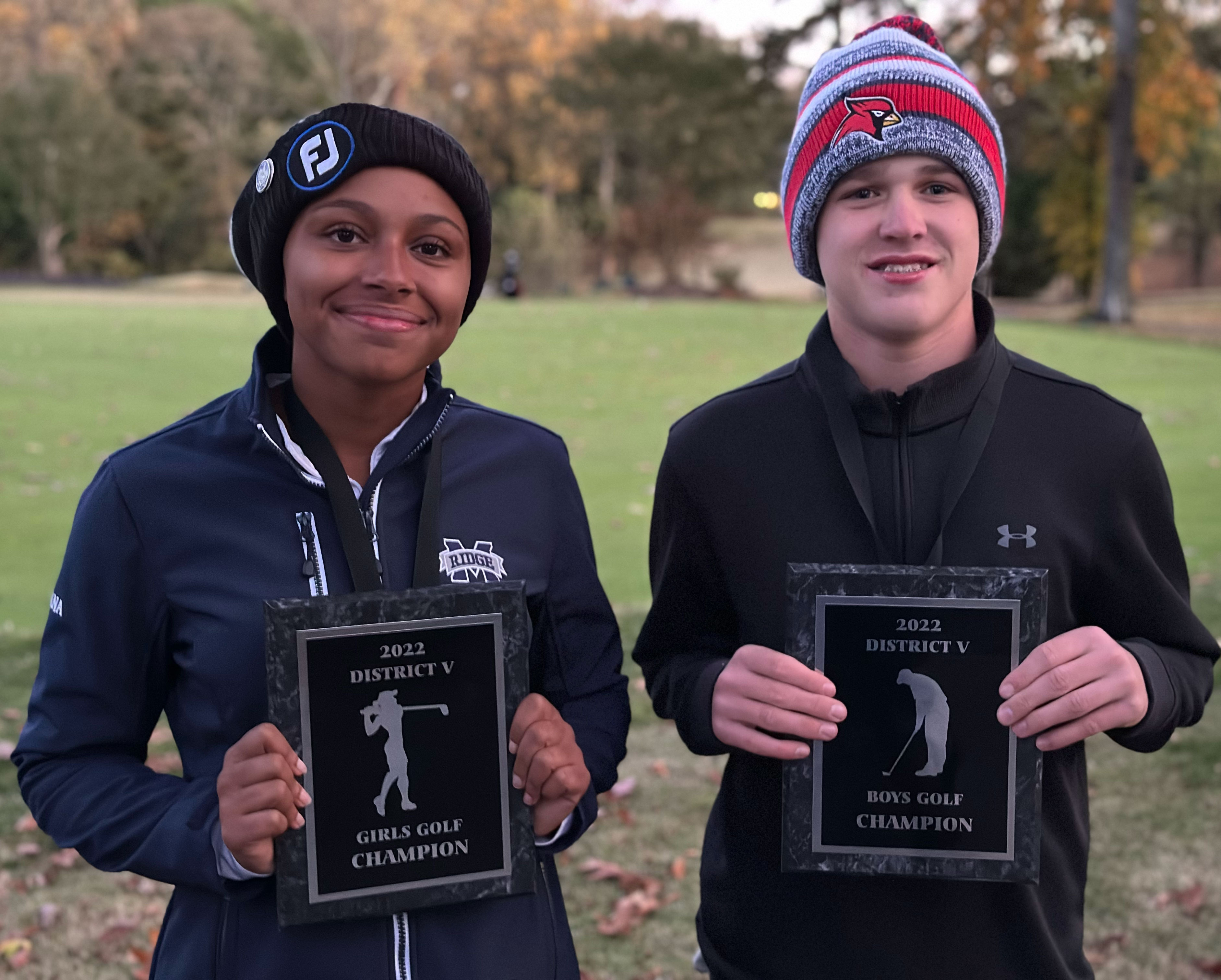 Champions Alana Alexander-Giles of Marriotts Ridge and Owen Newberry of Crofton pose together after winning their respective titles at the District V golf championships.