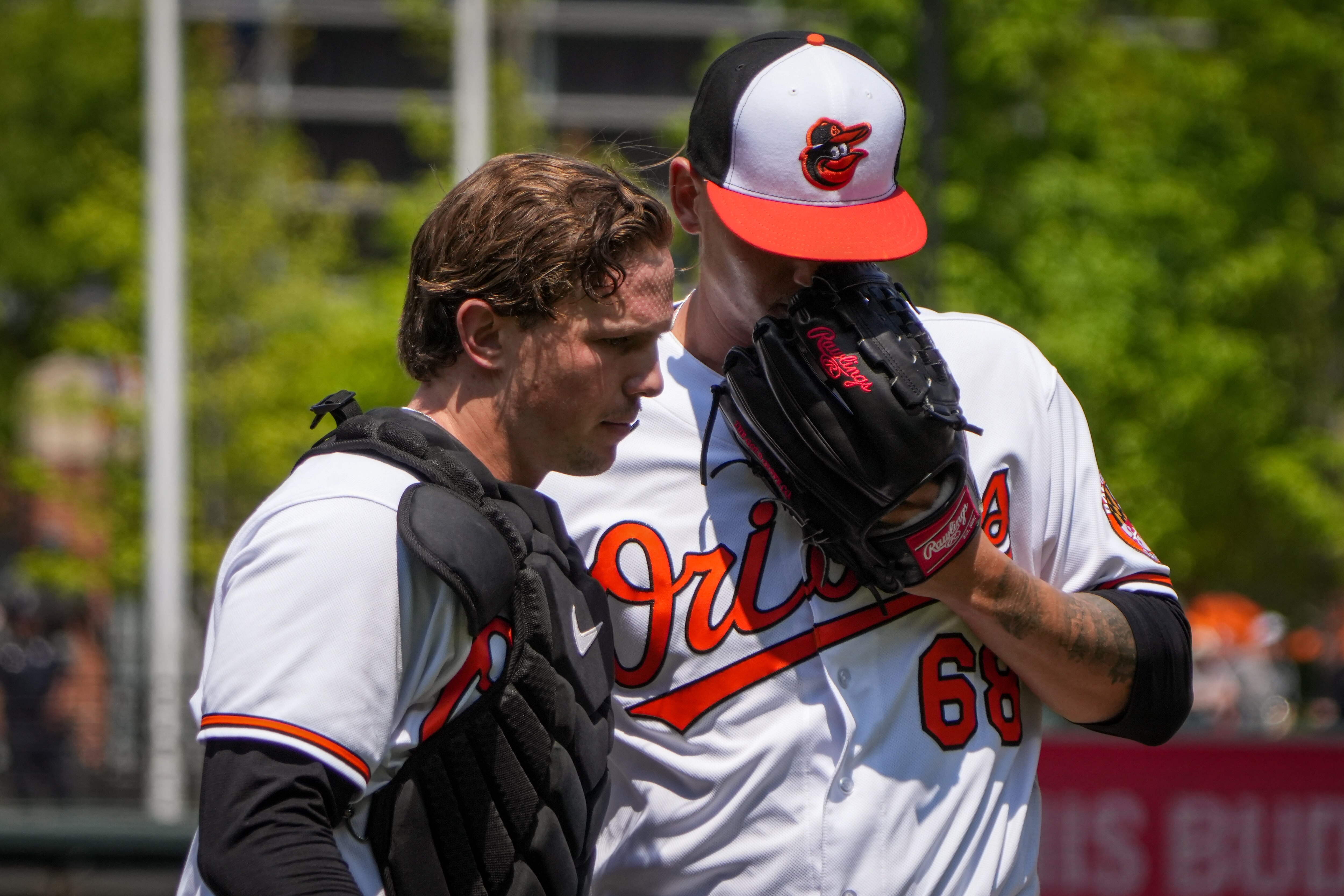 Baltimore Orioles starting pitcher Tyler Wells (68) and catcher Adley Rutschman (35) speak together as they return to the dugout in a baseball game against the Boston Red Sox at Camden Yards on Wednesday, April 26. The Orioles played the Red Sox in the third game of the series, with the winner of Wednesday's game taking the series.