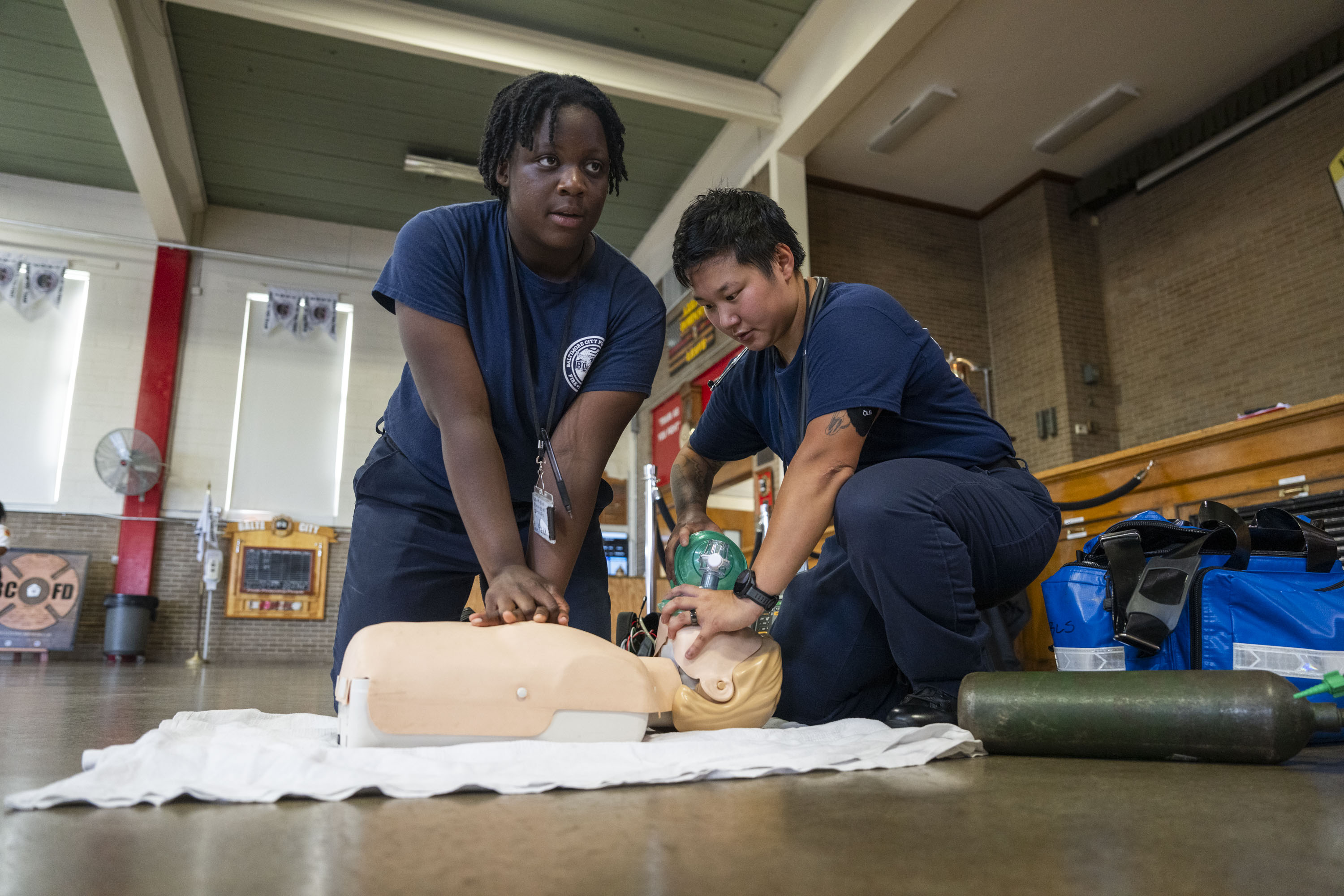 Recruits Olayemi Harleston, left, and Helen Odenwald perform a CPR training exercise at the BCFD Fire Academy on Friday.