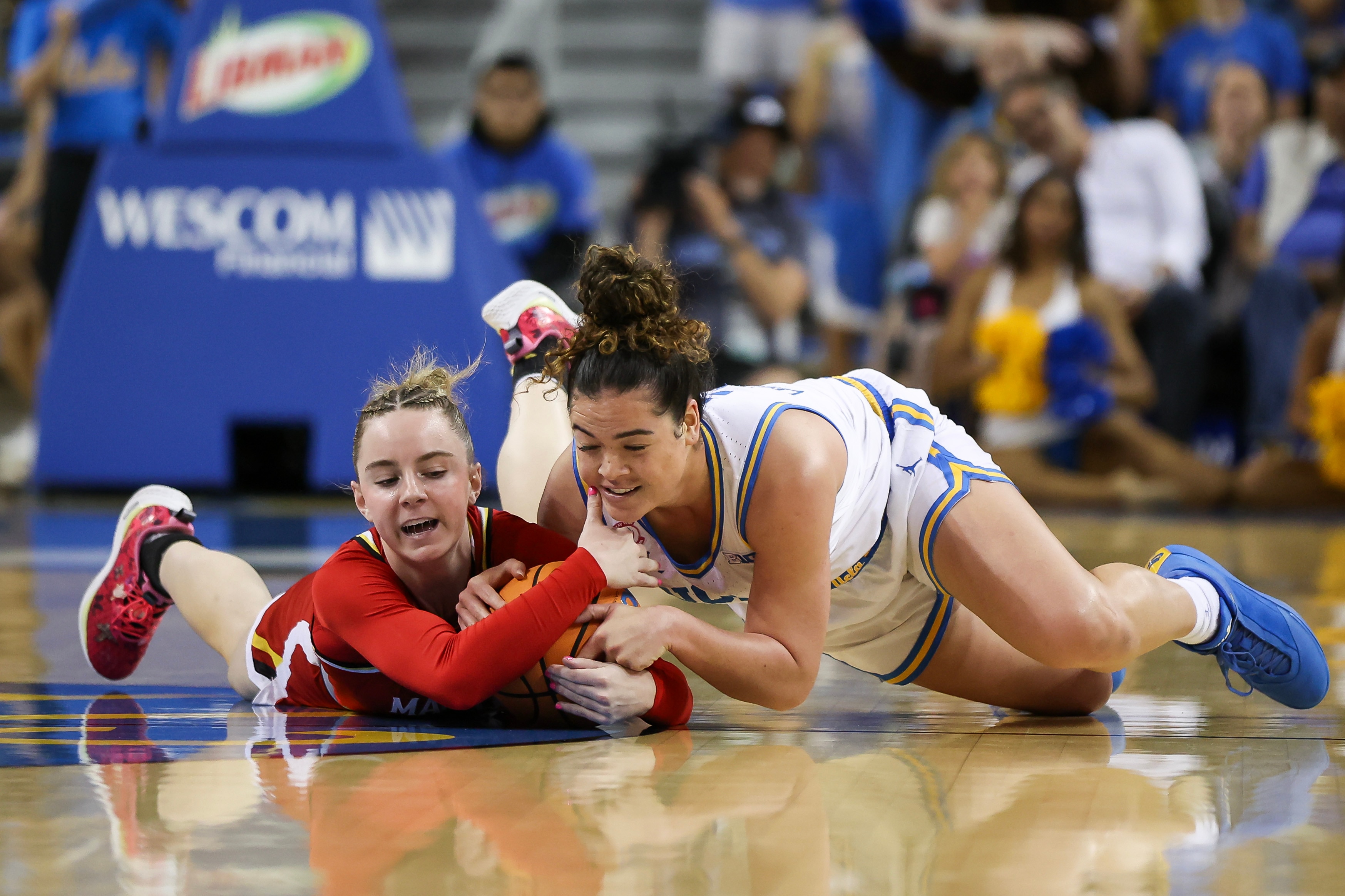 Addi Mack of Maryland, left, and Charlisse Leger-Walker of UCLA fight for the ball Sunday.