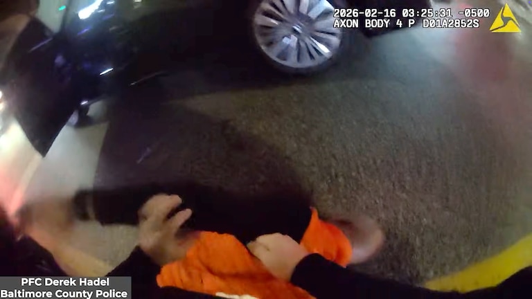 Baltimore County Police Officer Derek Hadel moves to handcuff Samuel “Big Sam” Brown Jr. after knocking him into the asphault.