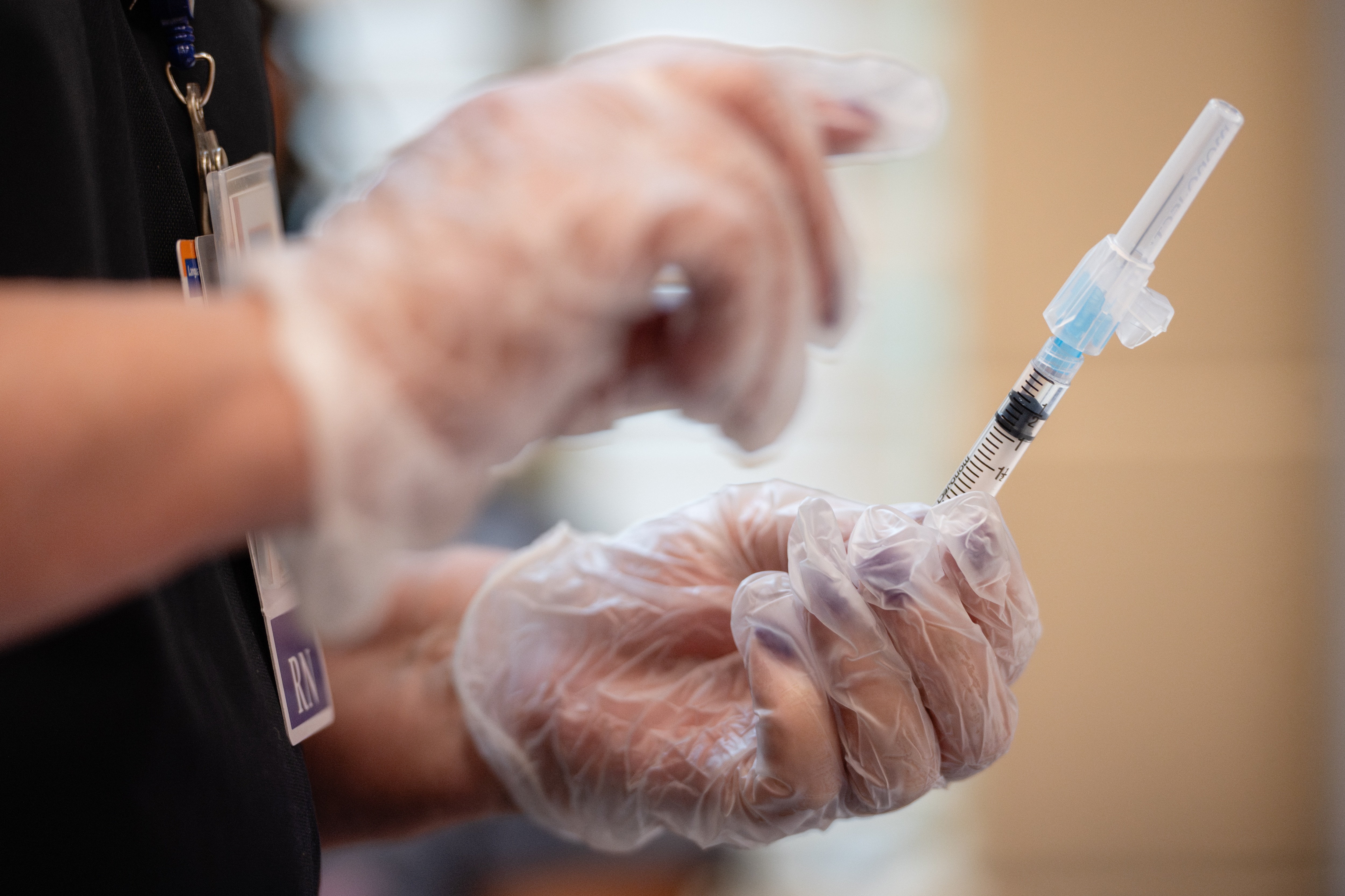 Reva Bounan, RN, holds a syringe to be used during a Vaccine Clinic offered at BCPS Fest held at New Town High School on August 16th, 2025 in Owings Mills, MD.