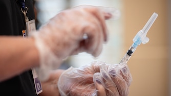 Reva Bounan, RN, holds a syringe to be used during a Vaccine Clinic offered at BCPS Fest held at New Town High School on August 16th, 2025 in Owings Mills, MD.