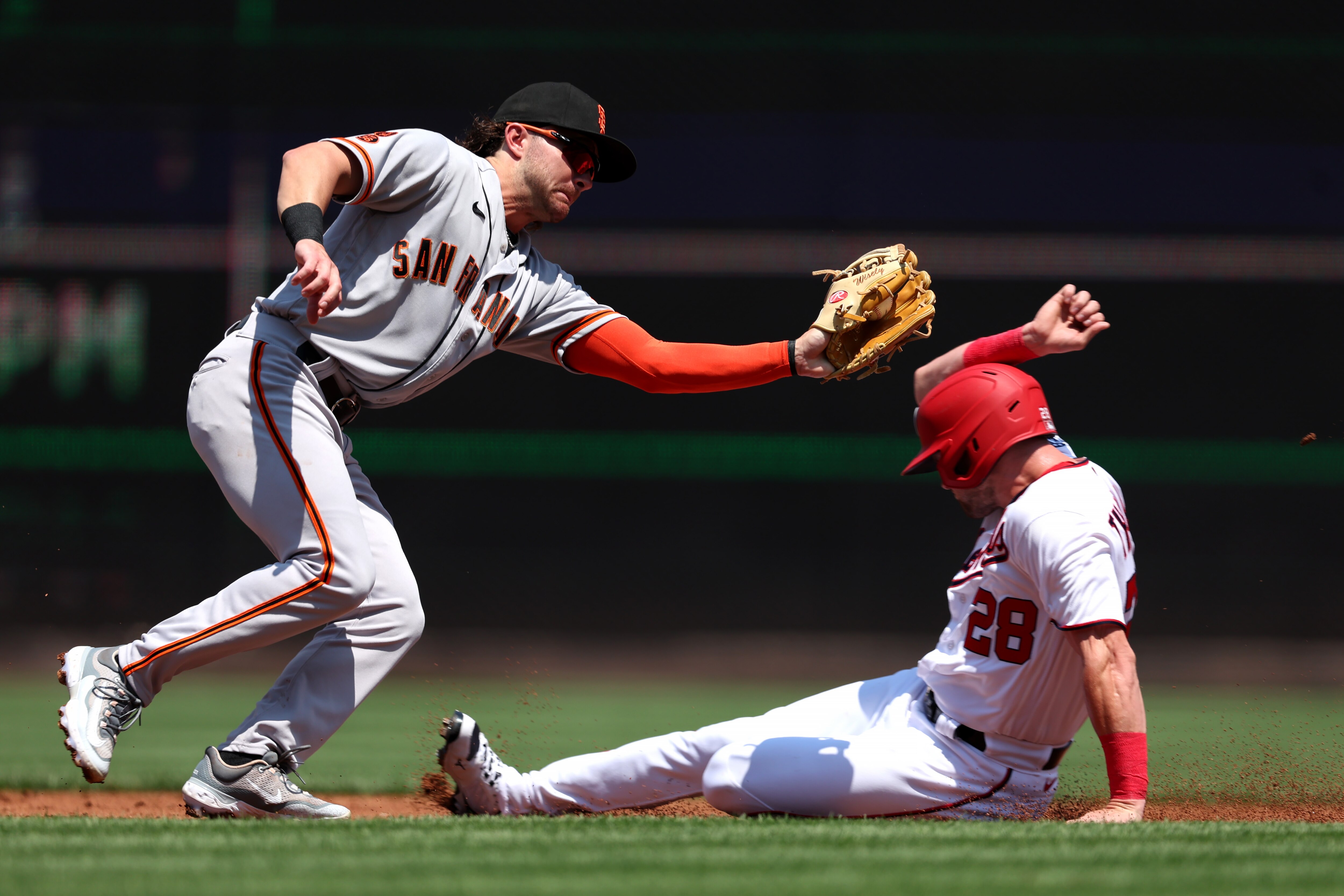 The Nationals' Lane Thomas slides in for one of his four stolen bases in Sunday's 6-1 win over the Giants.
