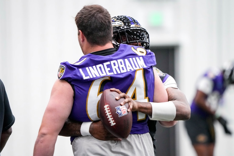 Baltimore Ravens quarterback Lamar Jackson (8) hugs center Tyler Linderbaum (64) during the team’s first Organized Team Activity session (OTA) of the year at the Under Armour Perforamance Center in Owings Mills, Md. on Wednesday, May 28, 2025.