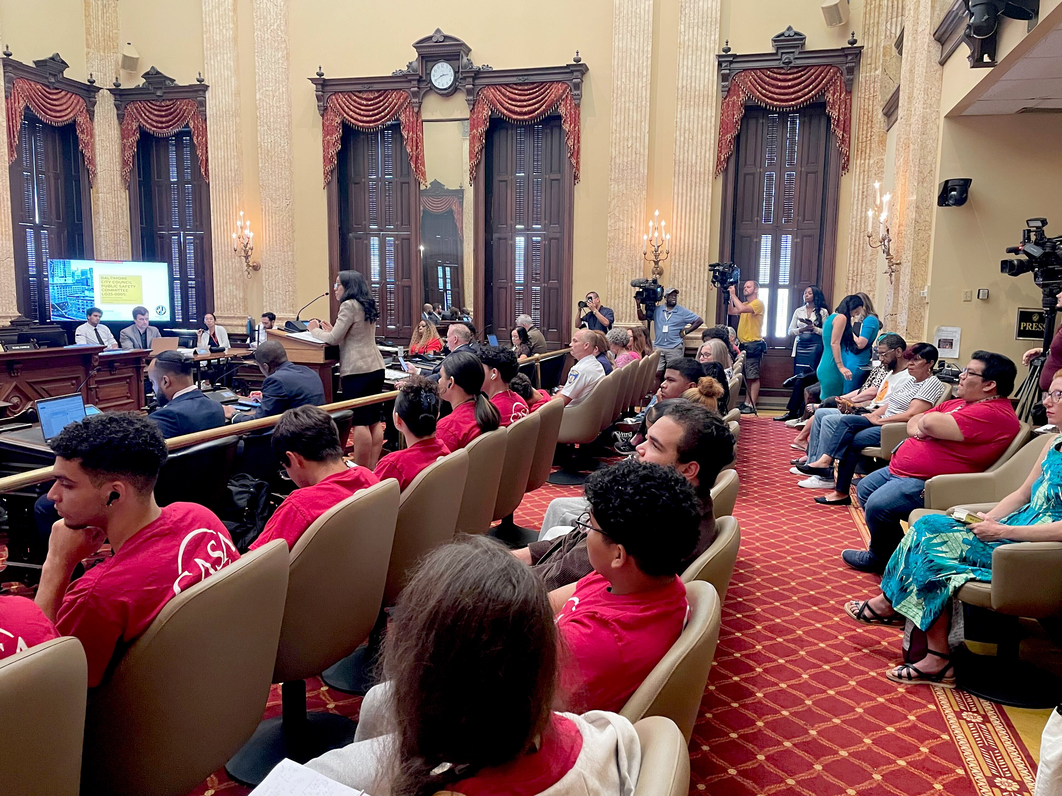 Amber Greene, director of the Mayor’s Office of Equity and Civil Rights, speaks as Baltimore residents crowd the City Council’s Public Safety Committee meeting on police accountability on Tuesday to condemn police-related deaths.