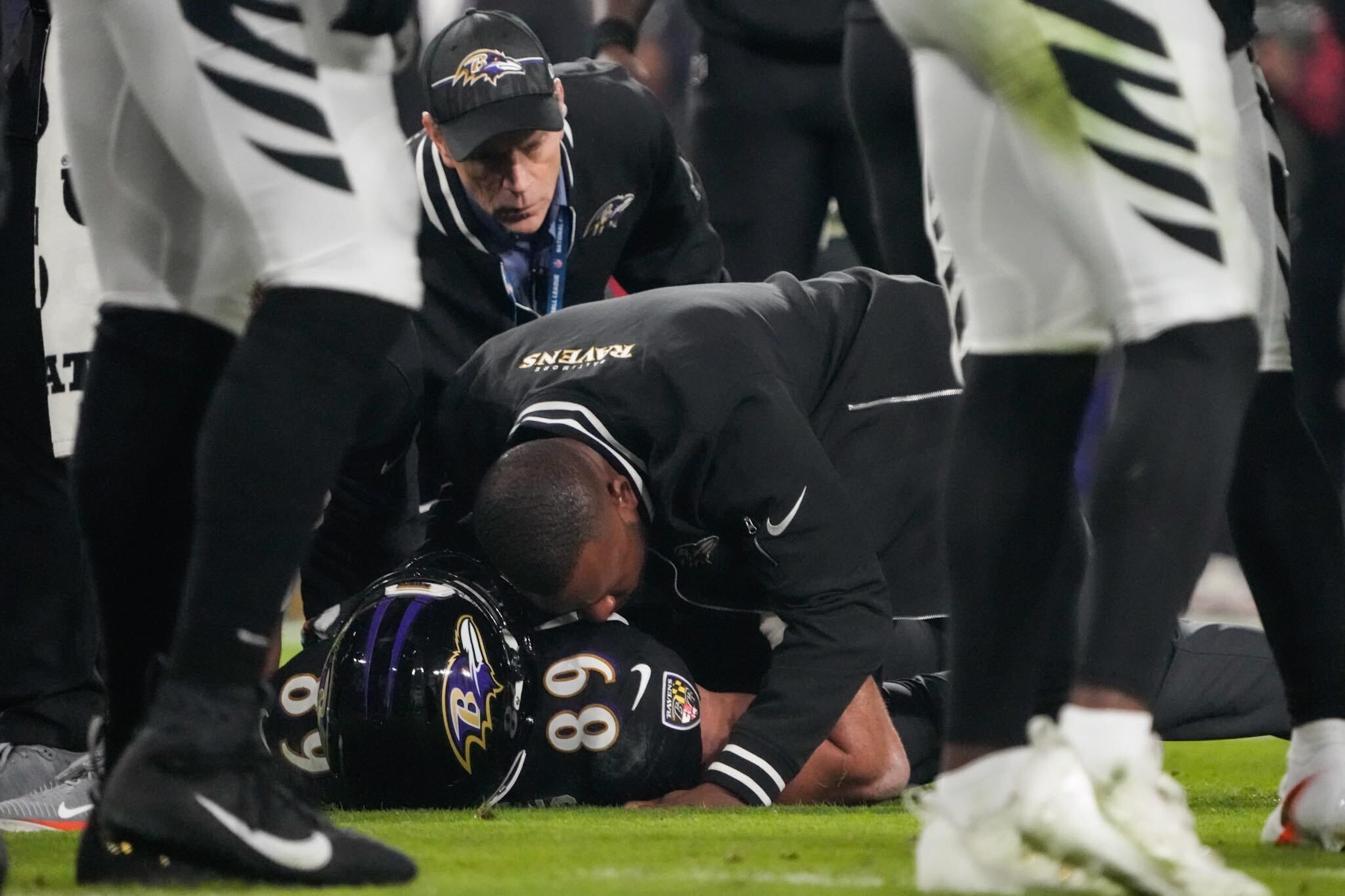 Ravens tight end Mark Andrews speaks with Ravens trainers after being injured on the first drive Thursday night against the Bengals.