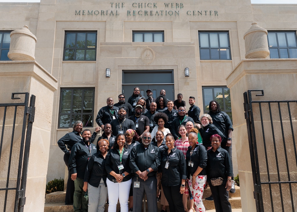 Thursday, April 16, 2026, in Baltimore — Baltimore City Recreation & Parks Director Dr. Reginald Moore poses with other BCRP staff during the grand reopening of the Chick Webb Memorial Recreation Center in East Baltimore.