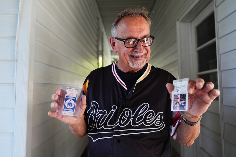 Baltimore Orioles fan Rick Taylor holds two newly-acquired tickets to add to his collection of tickets from almost every baseball game of Cal Ripken Jr.'s 2,632 game "Iron Man" streak.
