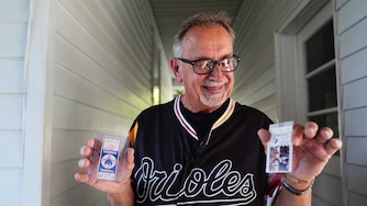 Baltimore Orioles fan Rick Taylor holds two newly-acquired tickets to add to his collection of tickets from almost every baseball game of Cal Ripken Jr.'s 2,632 game "Iron Man" streak.