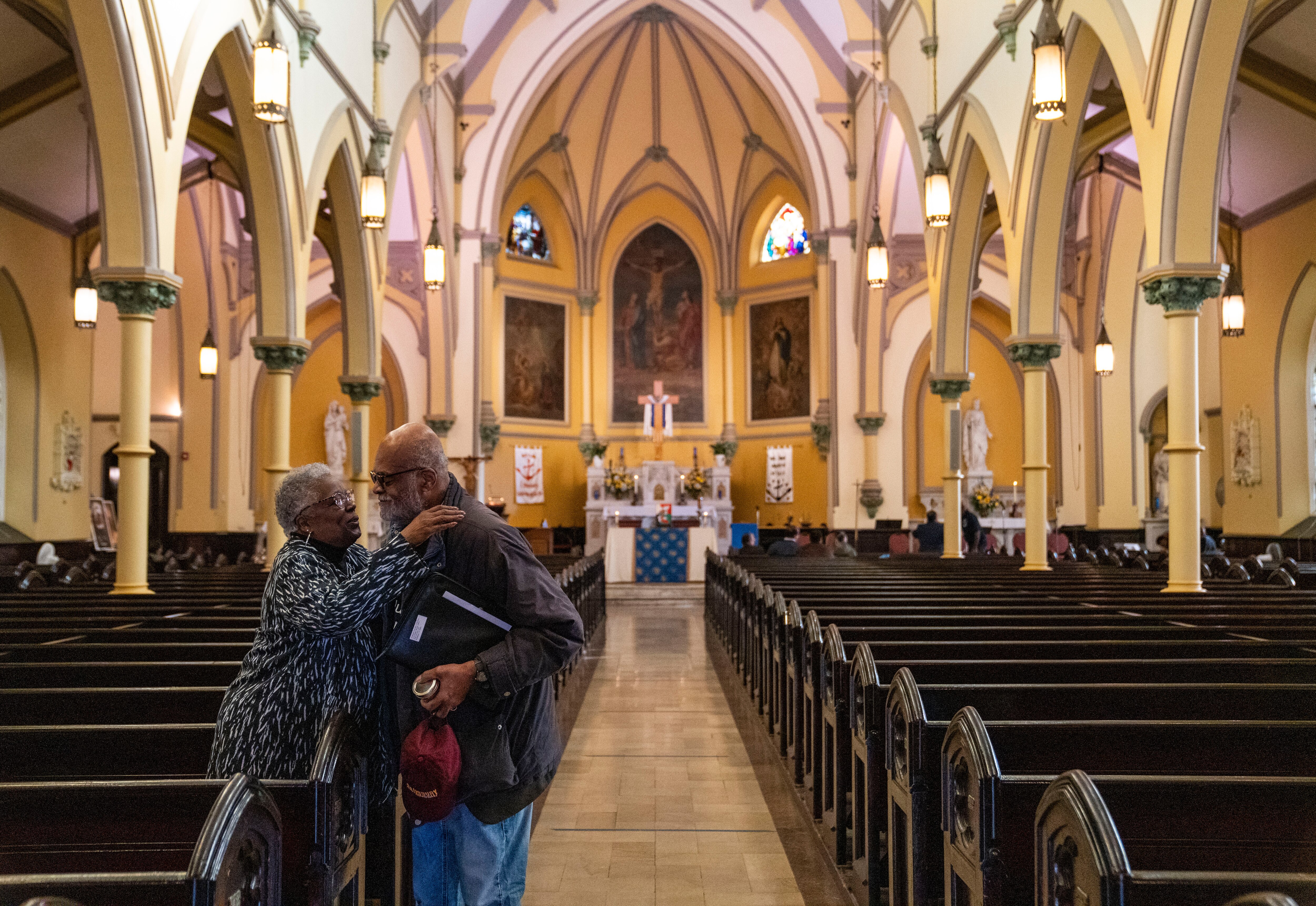 Harriette Lowery hugs Ralph Moore before mass at St. Ann’s Church in Baltimore, Sunday, November 24, 2024.