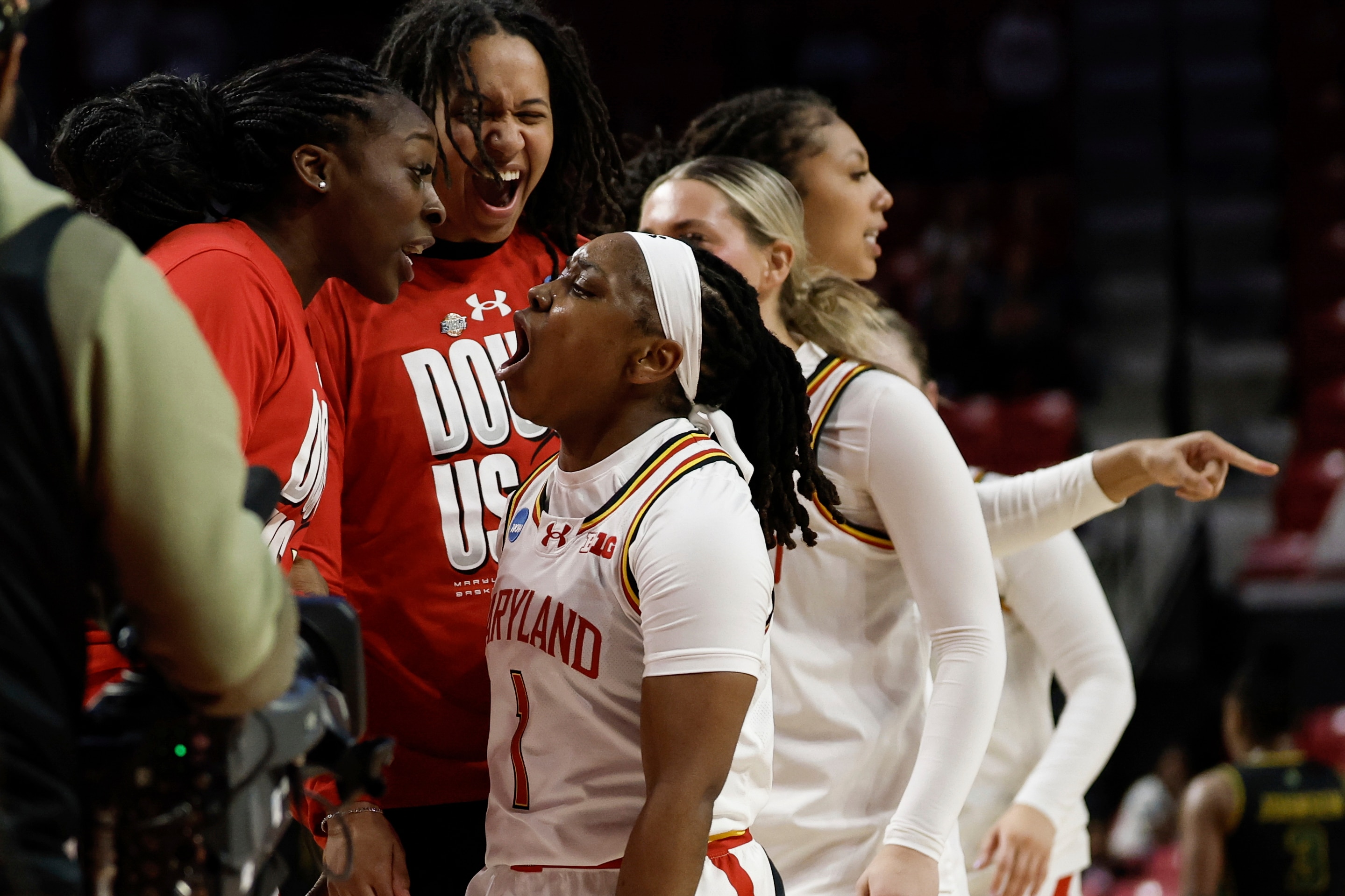 Maryland guard Sarah Te-Biasu (1) celebrates a made  3-point basket with her teammates during the second half against Norfolk State in the first round of the NCAA college basketball tournament, Saturday, March 22, 2025, in College Park, Md. (AP Photo/Terrance Williams)
