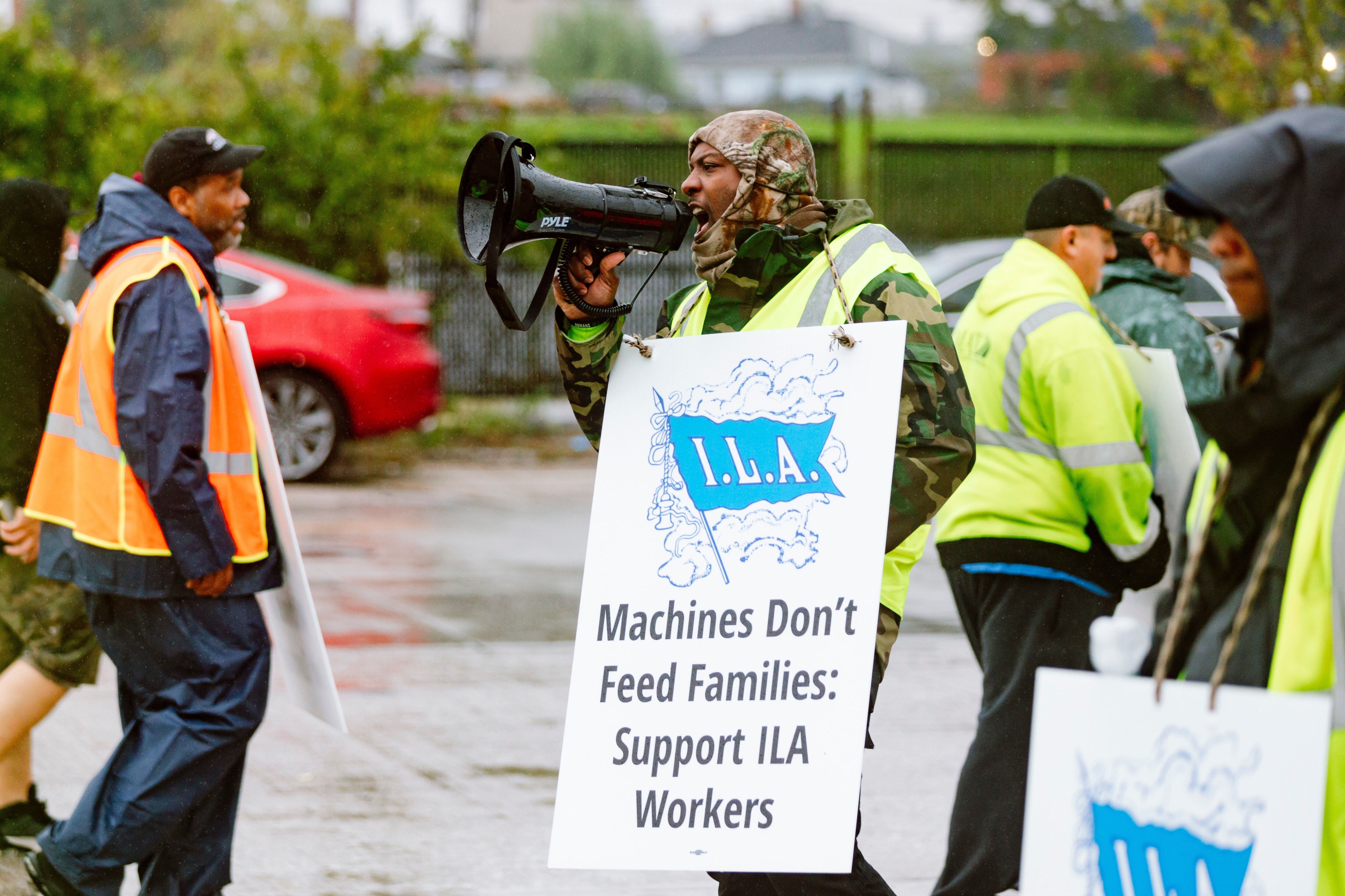 Union members with the International Longshoremen’s Association and Local 333 continue to strike in the rain after over eight hours of picketing against the automation of port work and low wages outside the Dundalk Marine Terminal on Tuesday, October 1, 2024 in Baltimore, MD.