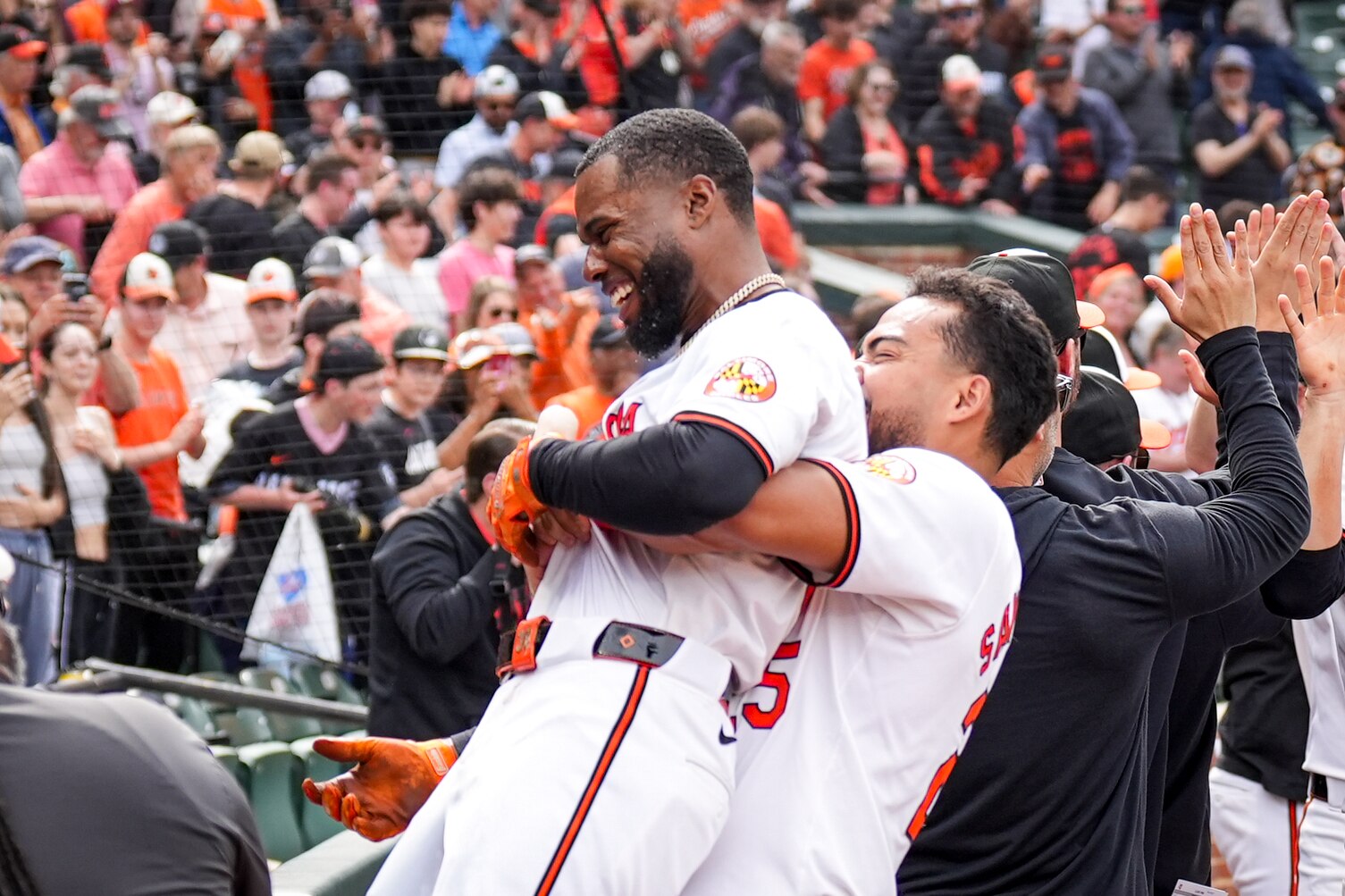 Baltimore Orioles outfielder Anthony Santander lifts his teammate Cedric Mullins in the air after his walk-off homer in game three of a series against the Minnesota Twins at Camden Yards on April 17, 2024. The Orioles won Wednesday, 4-2, to sweep the series against the Twins.