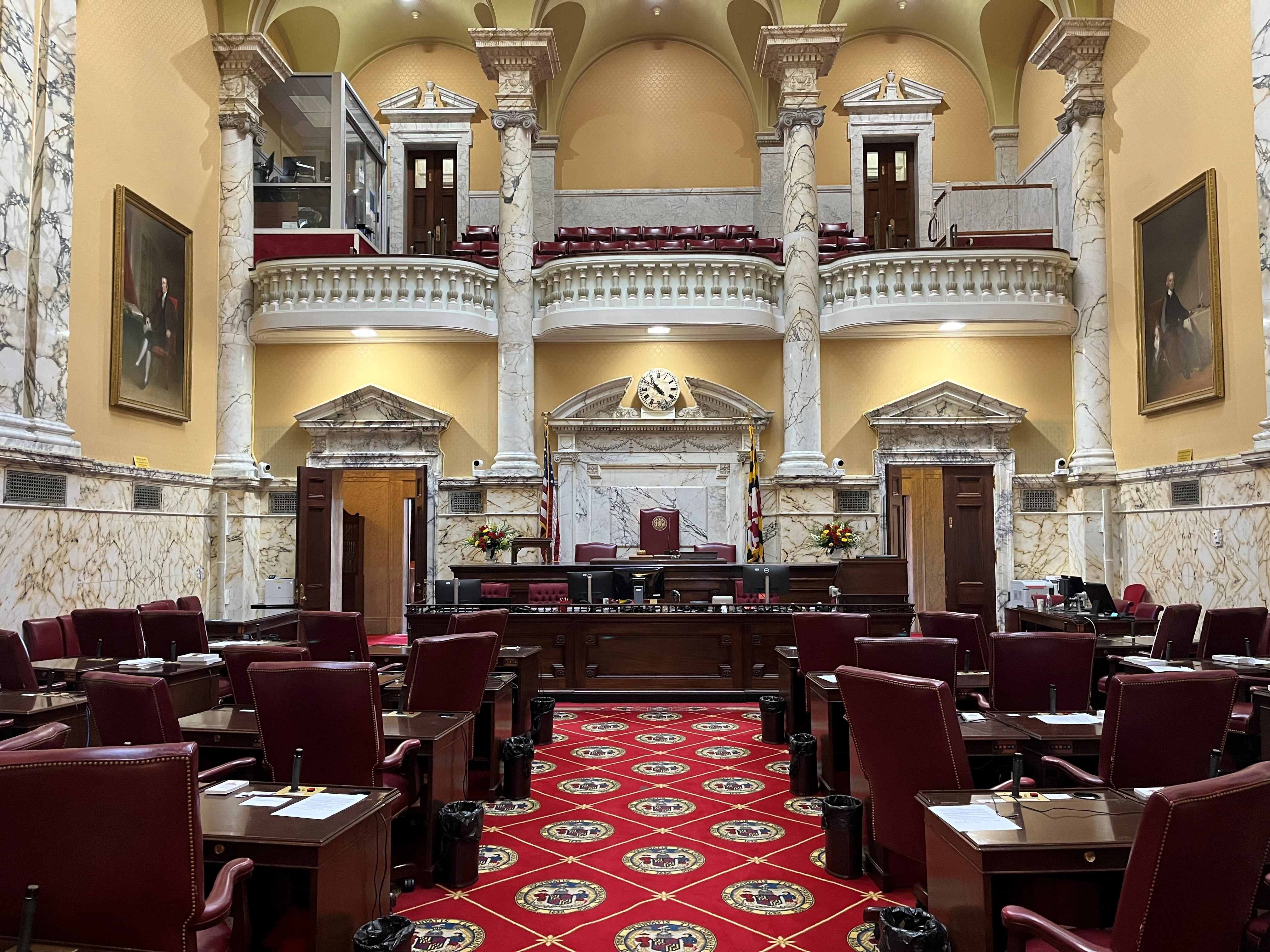 The Maryland Senate Chamber is decorated with the colors of the Maryland state flag.