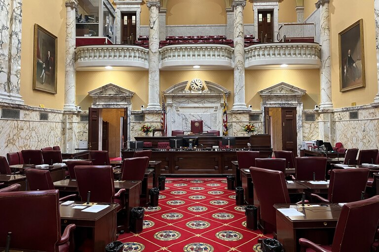 The Maryland Senate Chamber is decorated with the colors of the Maryland state flag.
