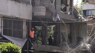 A rescue worker checks an apartment that was hit in an Israeli airstrike in Dahiyeh, Beirut's southern suburbs, Lebanon, Sunday, June 14, 2026.