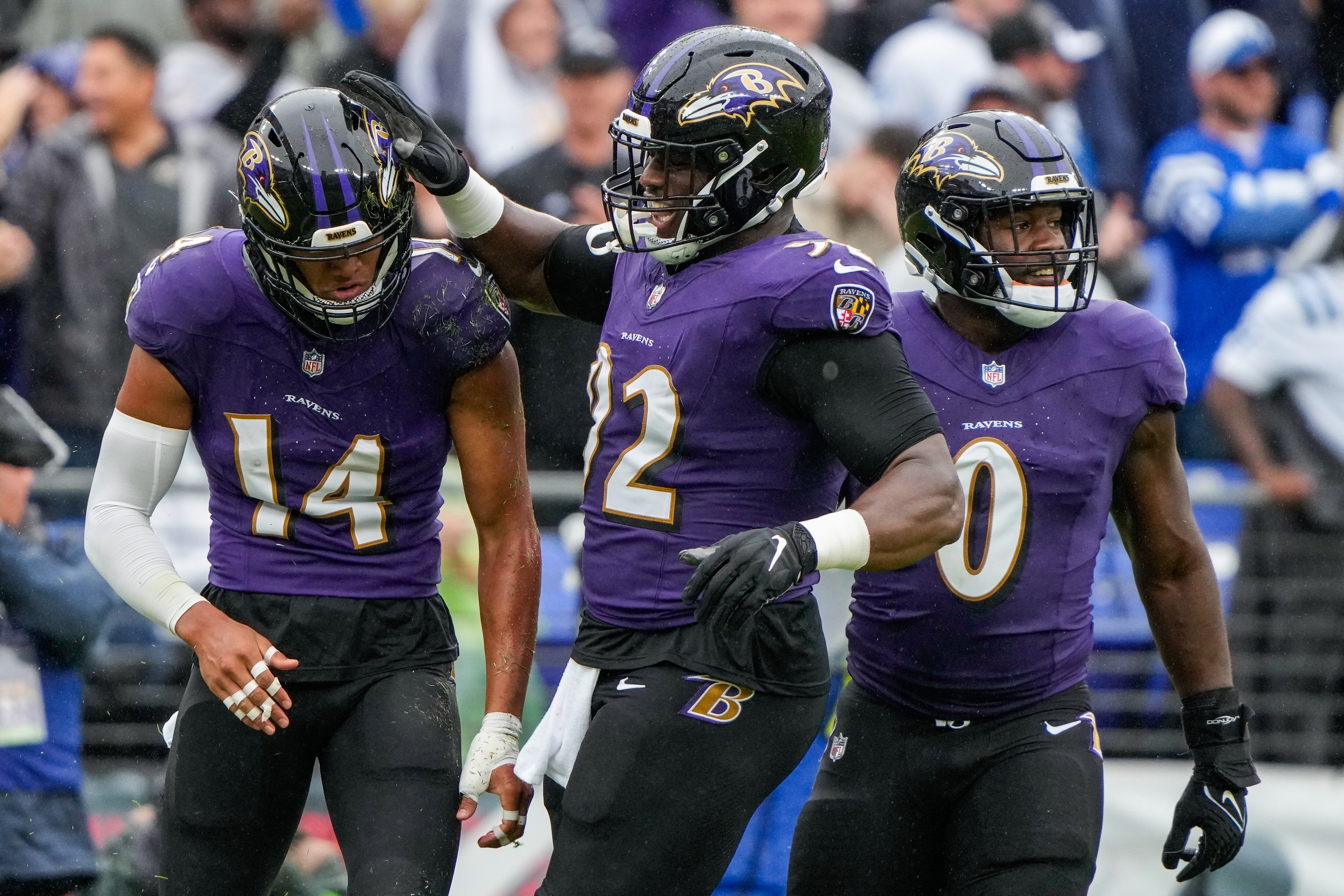 From left, Baltimore Ravens safety Kyle Hamilton (14), defensive tackle Justin Madubuike (92) and linebacker Roquan Smith (0) celebrate during the game against the Indianapolis Colts at M&T Bank Stadium on Sunday, Sept. 24, 2023.