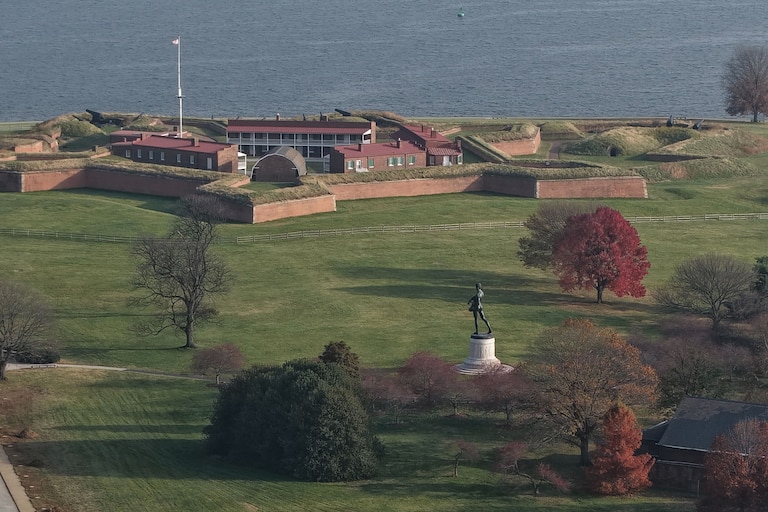 Baltimore Police block the road at East Fort Avenue leading to Fort McHenry on Friday, after sending its bomb squad as a safety measure after crews dug up an old explosive device.