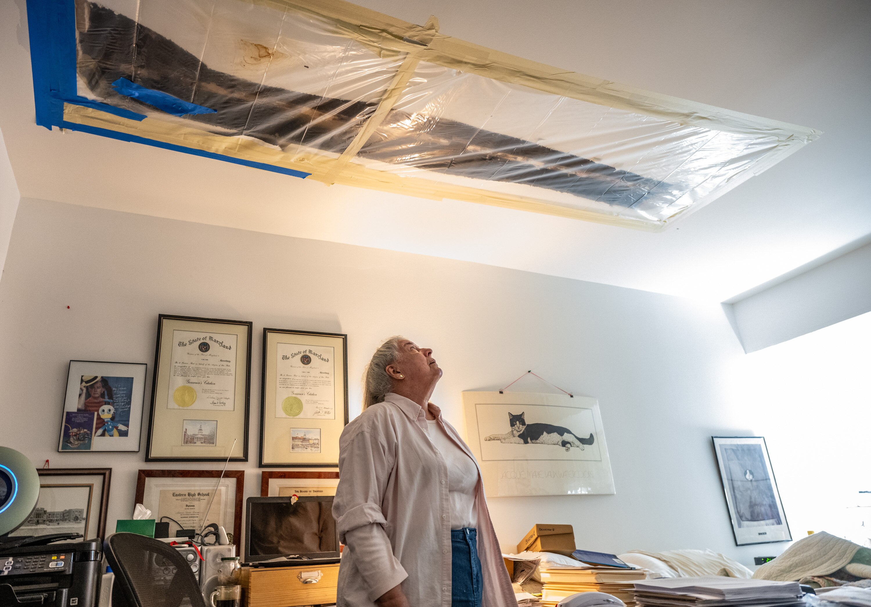 Rockland Run resident Diana Evans looks up at the damaged ceiling above her bed. She has had to deal with water coming through the ceiling in her first floor condo multiple times in the past couple of years.