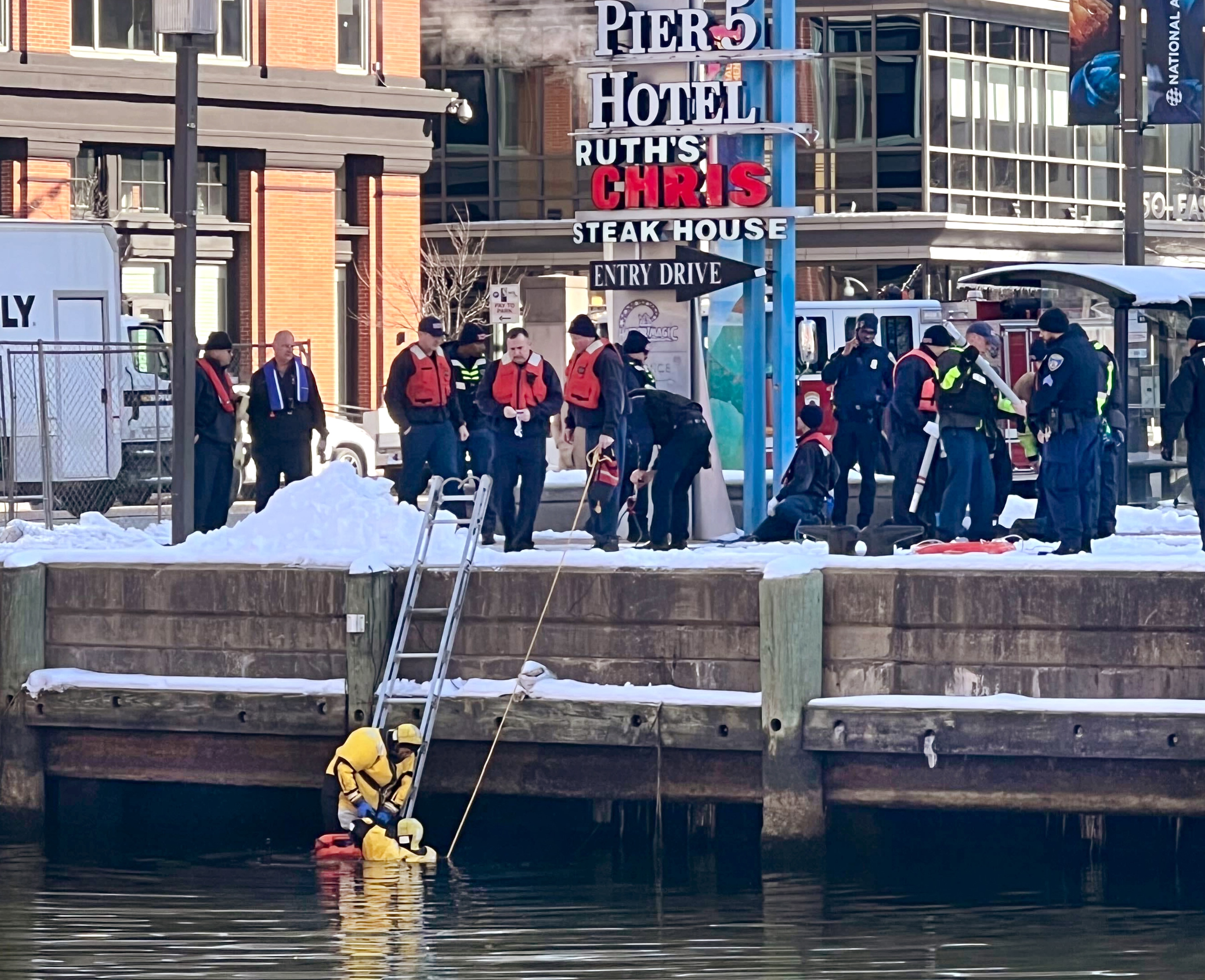 Baltimore police pull a body from the Harbor near the 600 block of E Pratt street.