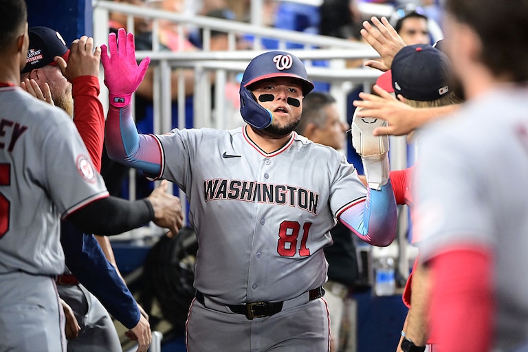 Abimelec Ortiz high fives teammates after scoring a run in the fourth inning against the Miami Marlins on Aug. 22.