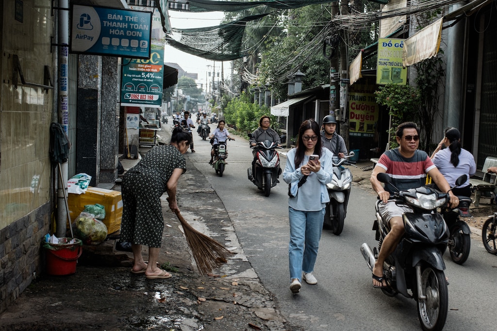 Dong Nai, Vietnam - July 26, 2026: Melissa Tran, 44, receives a video call from her son, Jacob, 11, while she walks around her childhood neighborhood in Dong Nai, Vietnam on July 26, 2026. Melissa left Vietnam when she was a child and so much has changed in her old neighborhood. She is looking forward to her family visiting her. Rosem Morton for The Baltimore Banner
