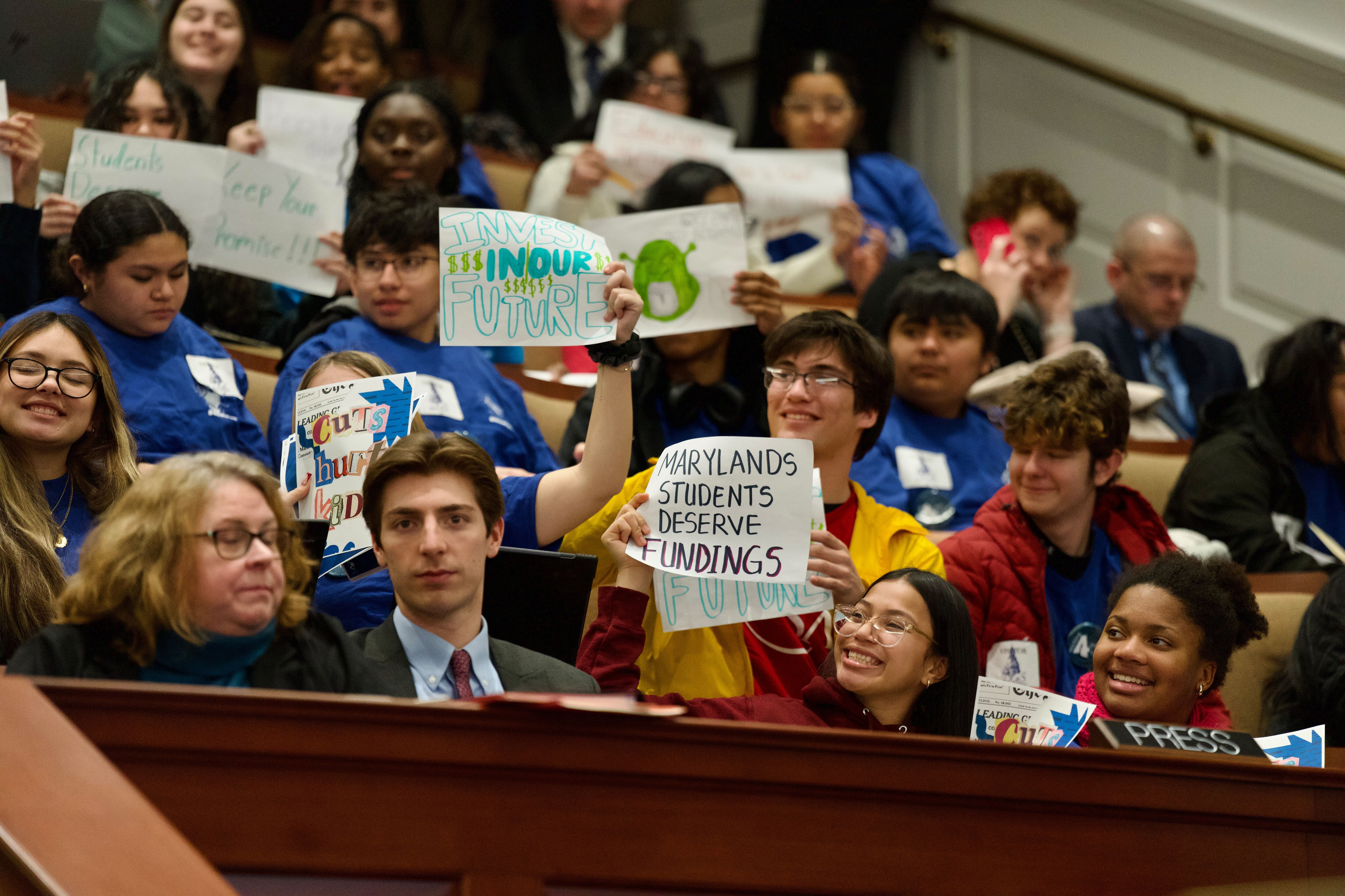 Students and other attendees hold signs during a joint bill hearing for the Excellence in Maryland Public Schools Act, Gov. Wes Moore‘s proposal to revamp the Blueprint for Maryland‘s Future.