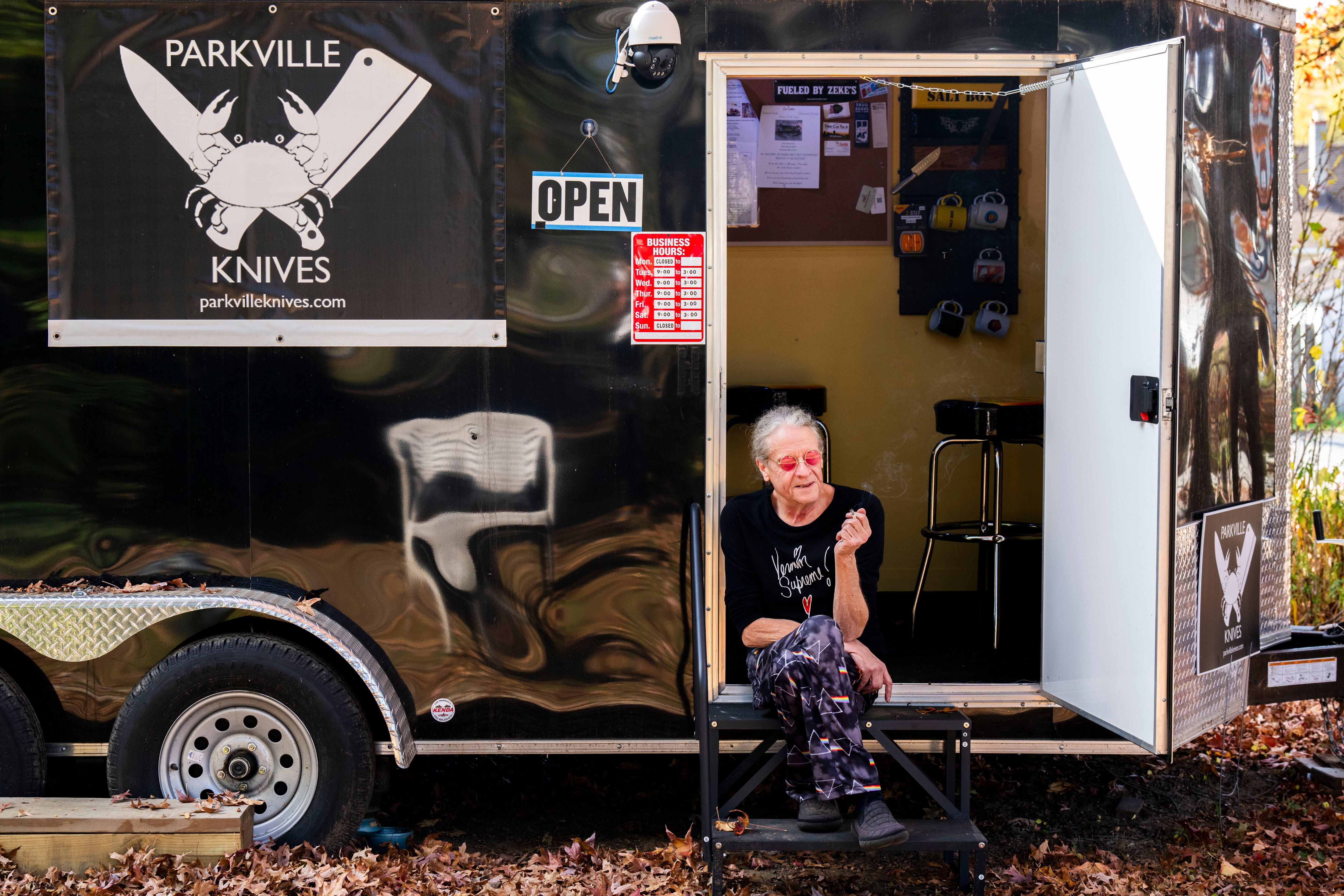 Robyn Webb has a knife sharpening business, Parkville Knives, at a trailer outside his house. He is pictured preparing for the busy Thanksgiving season on Nov. 9, 2023.