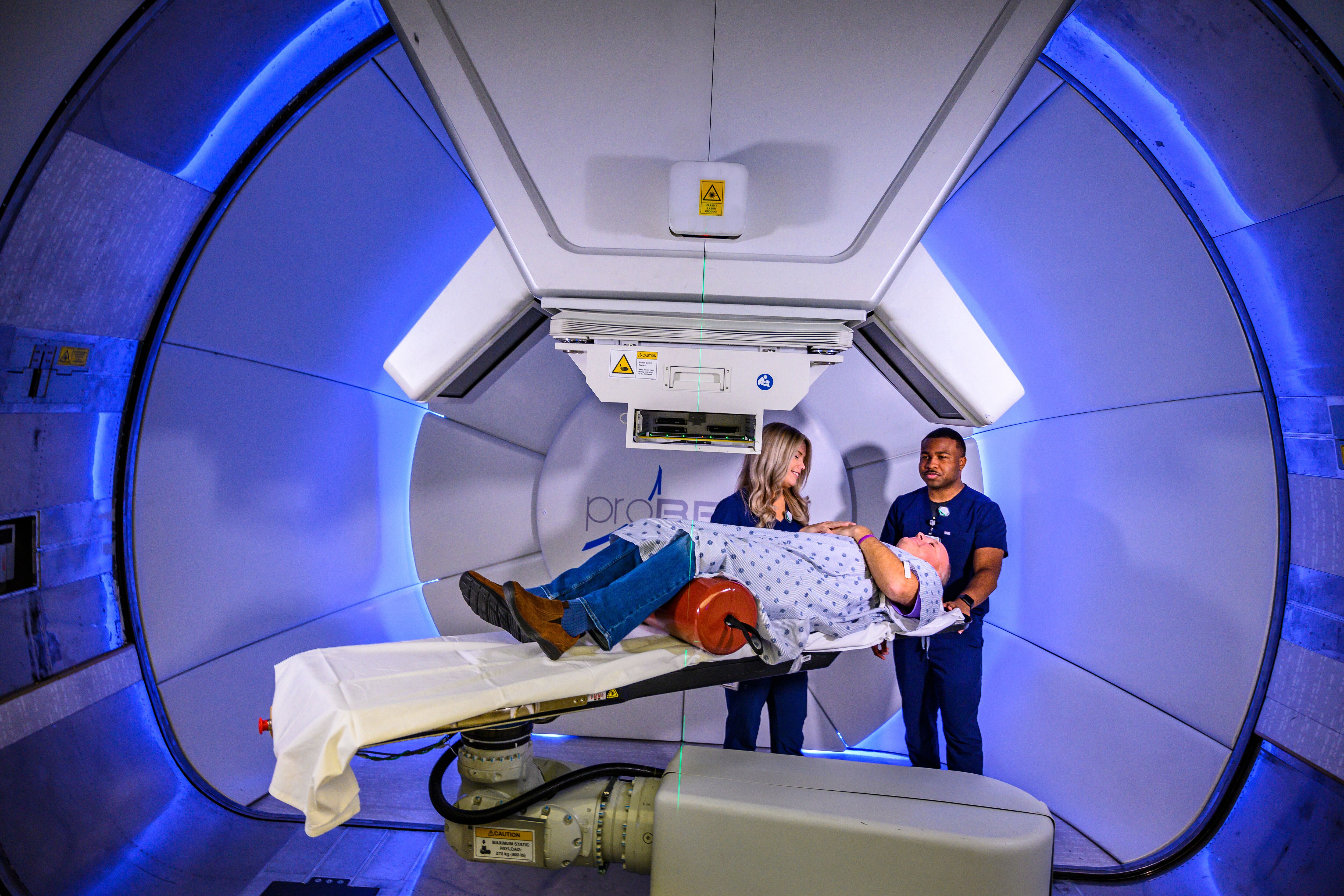 Radiation therapists preparing patient for treatment. (Photo credit: Stephen Spartana)