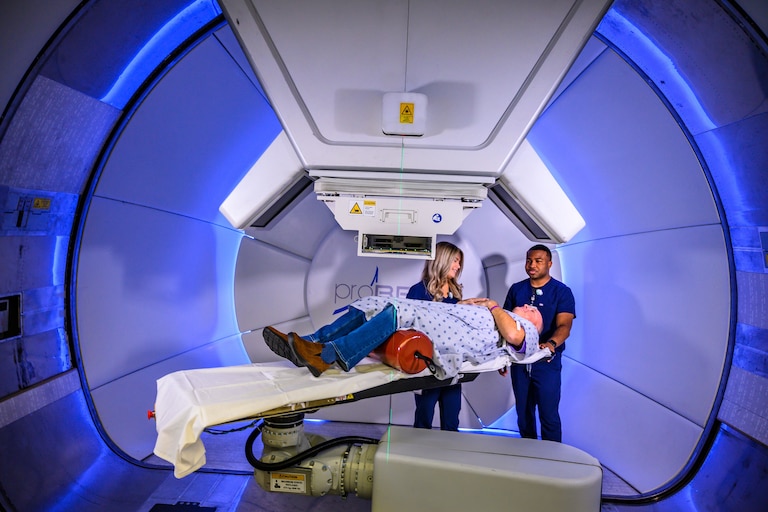 Radiation therapists preparing patient for treatment. (Photo credit: Stephen Spartana)