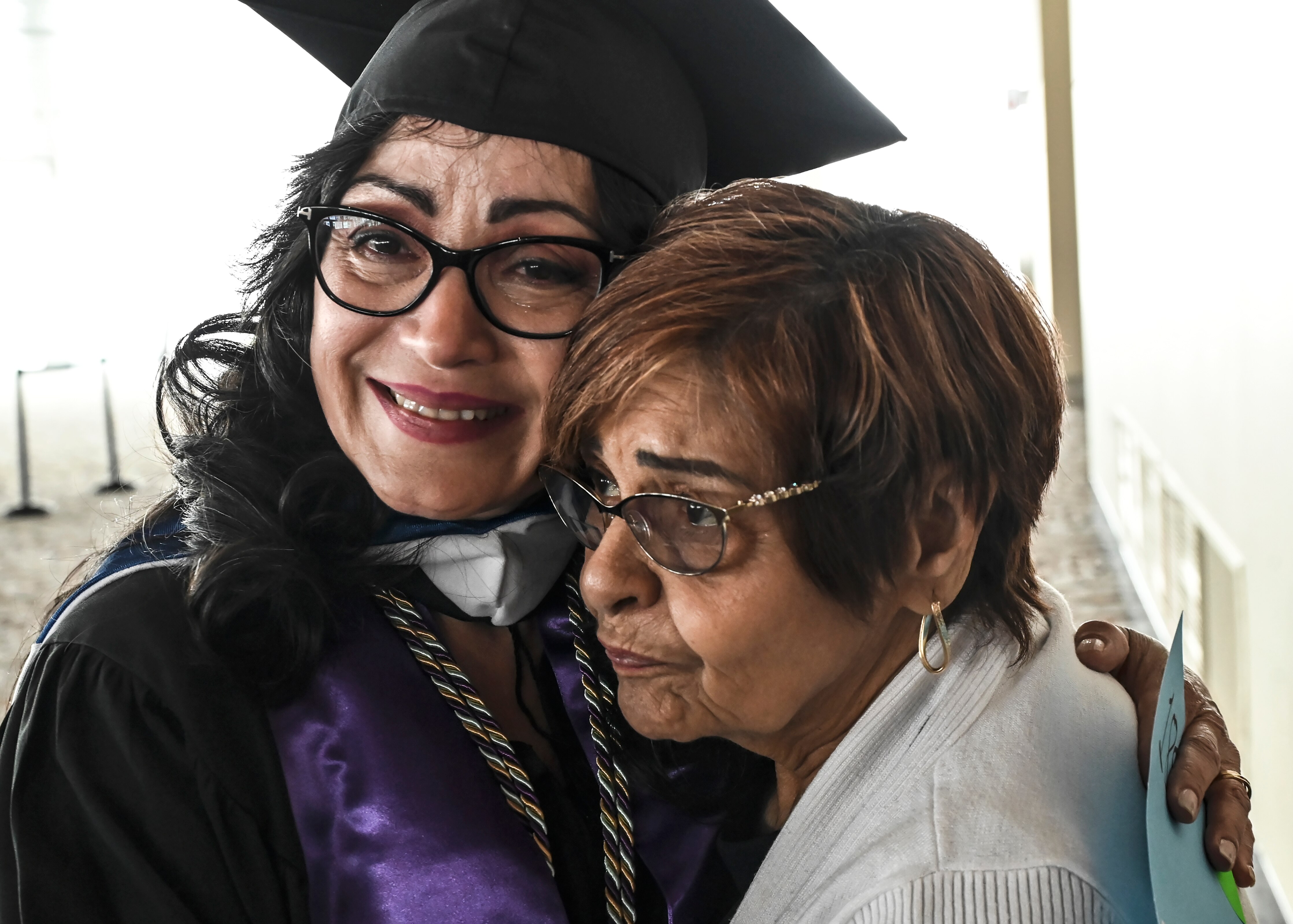 New NDMU grad Brenda Rivera hugs her Candy Figueroa.