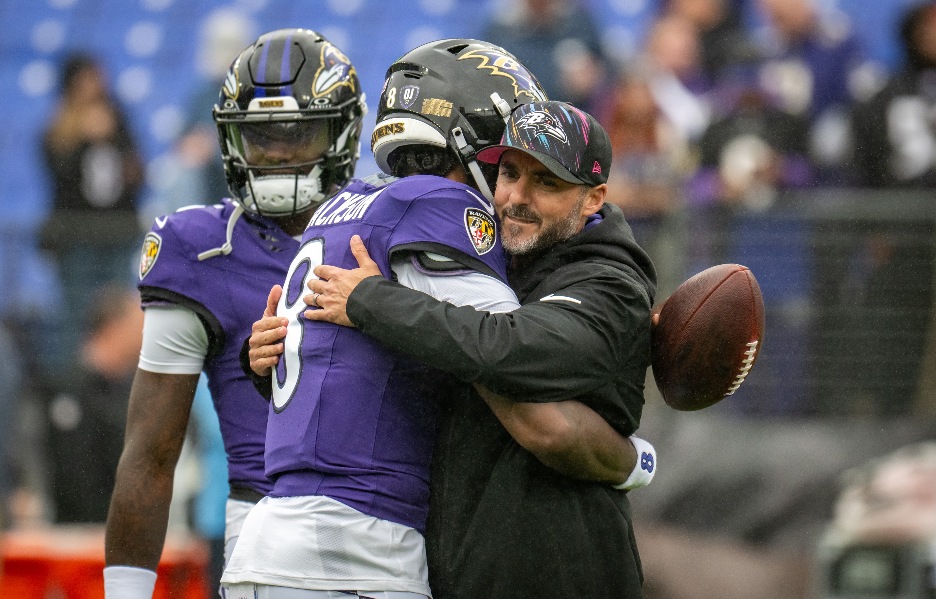Ravens quarterback Lamar Jackson and head coach Jesse Minter hug midfield before the team’s Oct. 4 game against the Tennessee Titans.