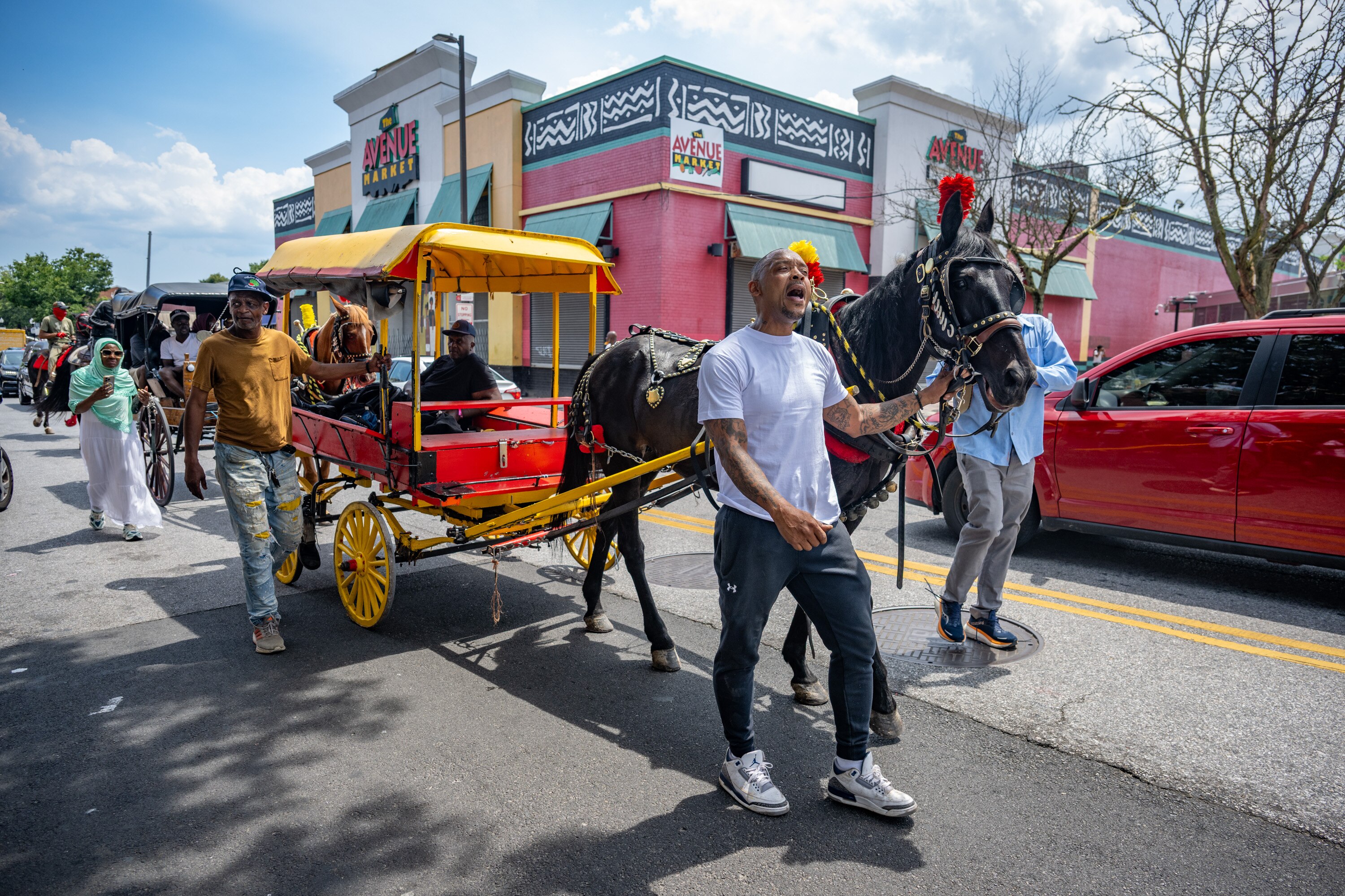 Levar Mullen calls out, “Fruit man, fruit man!,” as he leads the funeral procession down Pennsylvania Avenue for Bilal “BJ” Abdullah, the beloved arabber fatally shot by Baltimore Police this week.