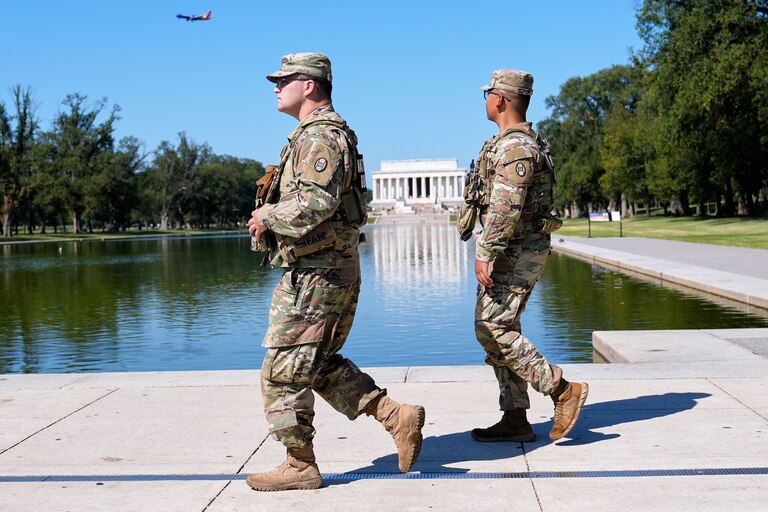 Members of the South Carolina National Guard patrol with the Lincoln Monument in the background.
